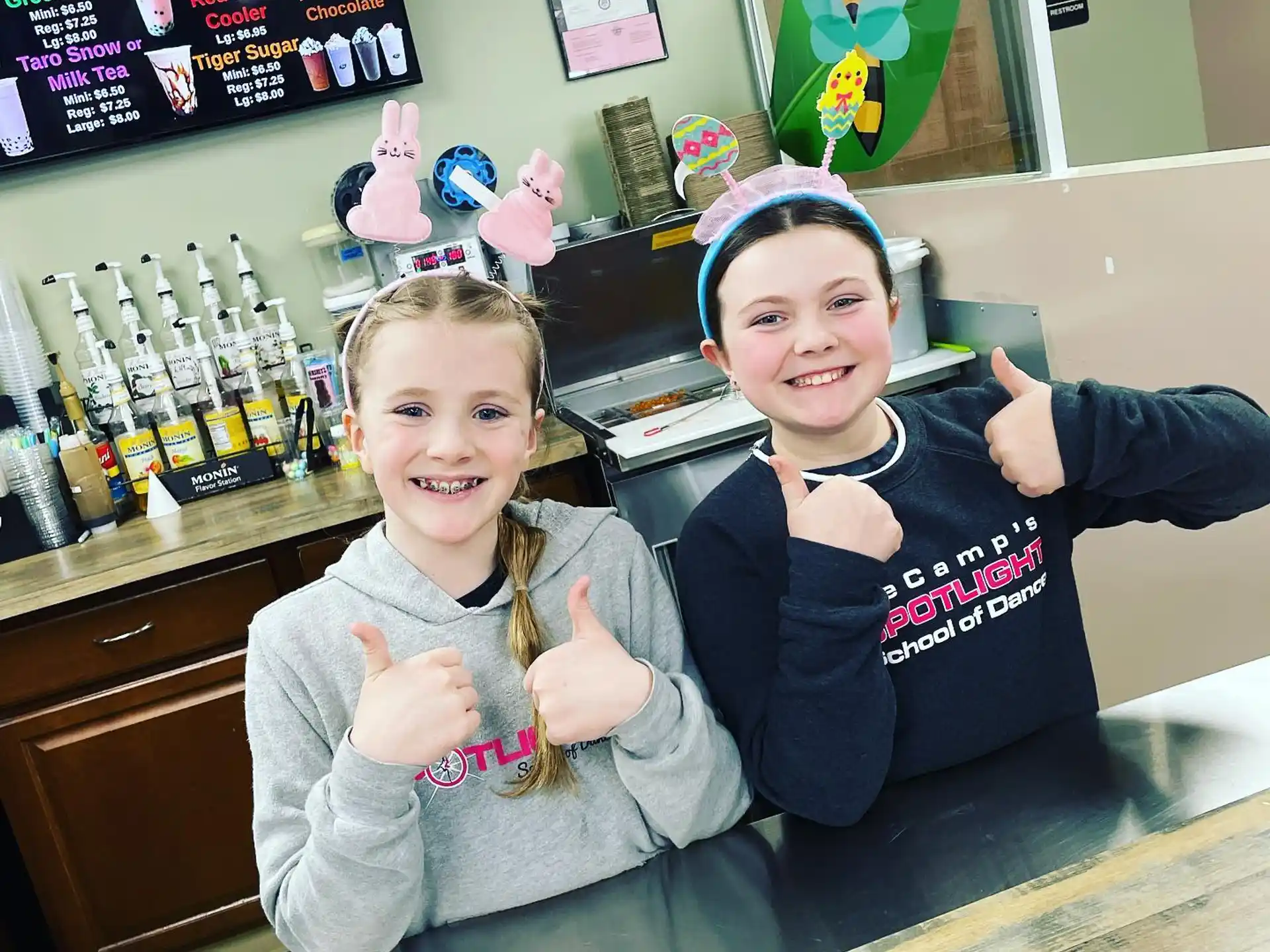 two children sitting at a bar