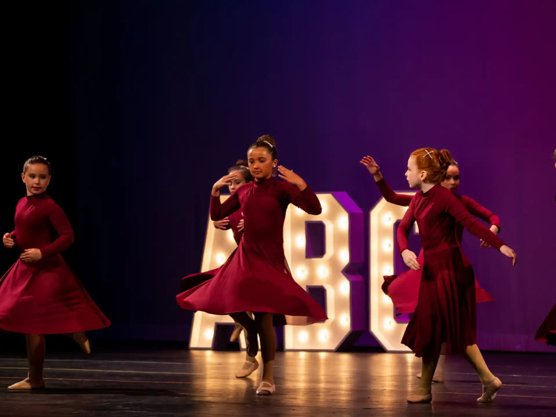 a group of women dancing on a stage