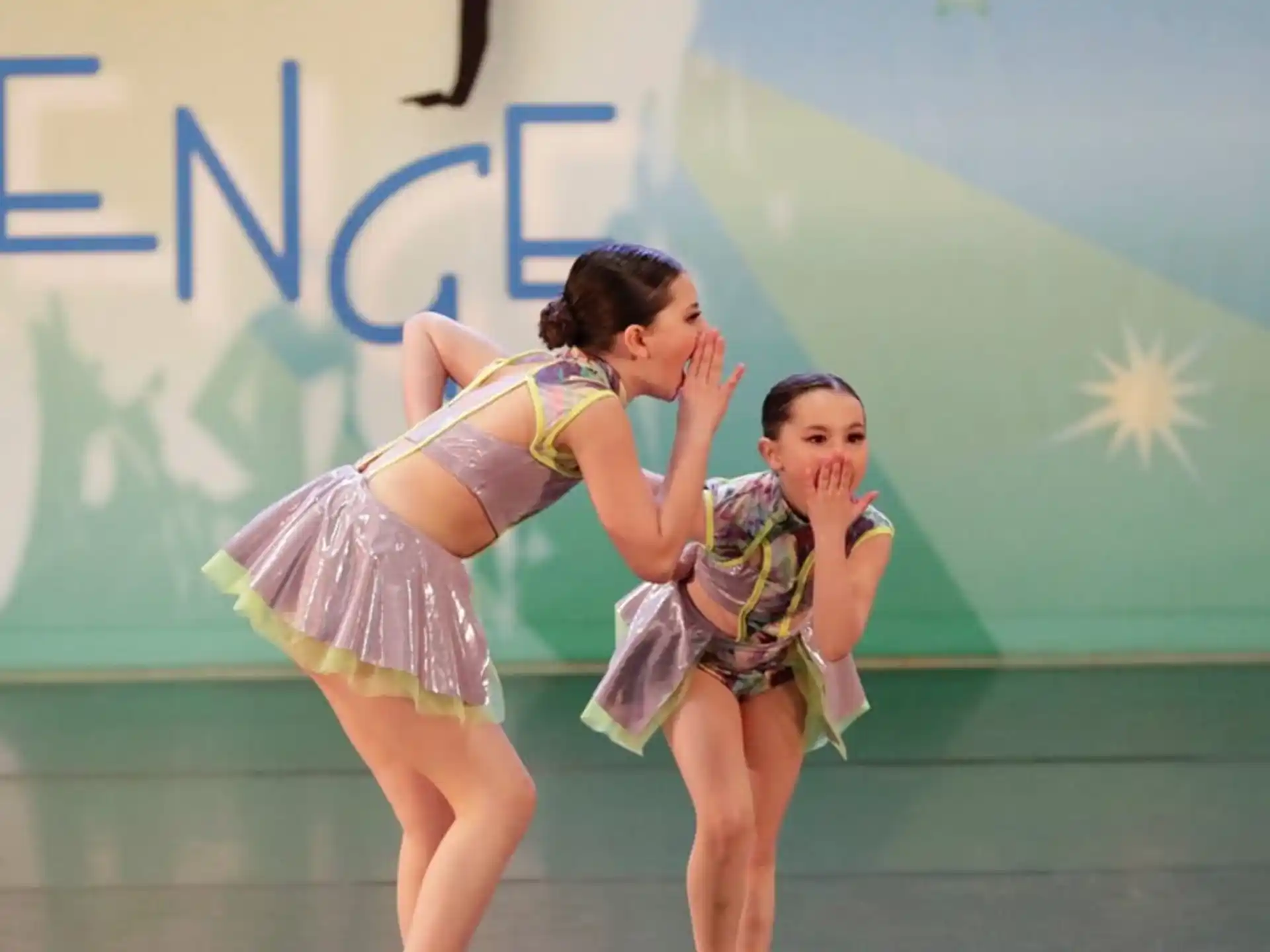 two women dancing on a stage