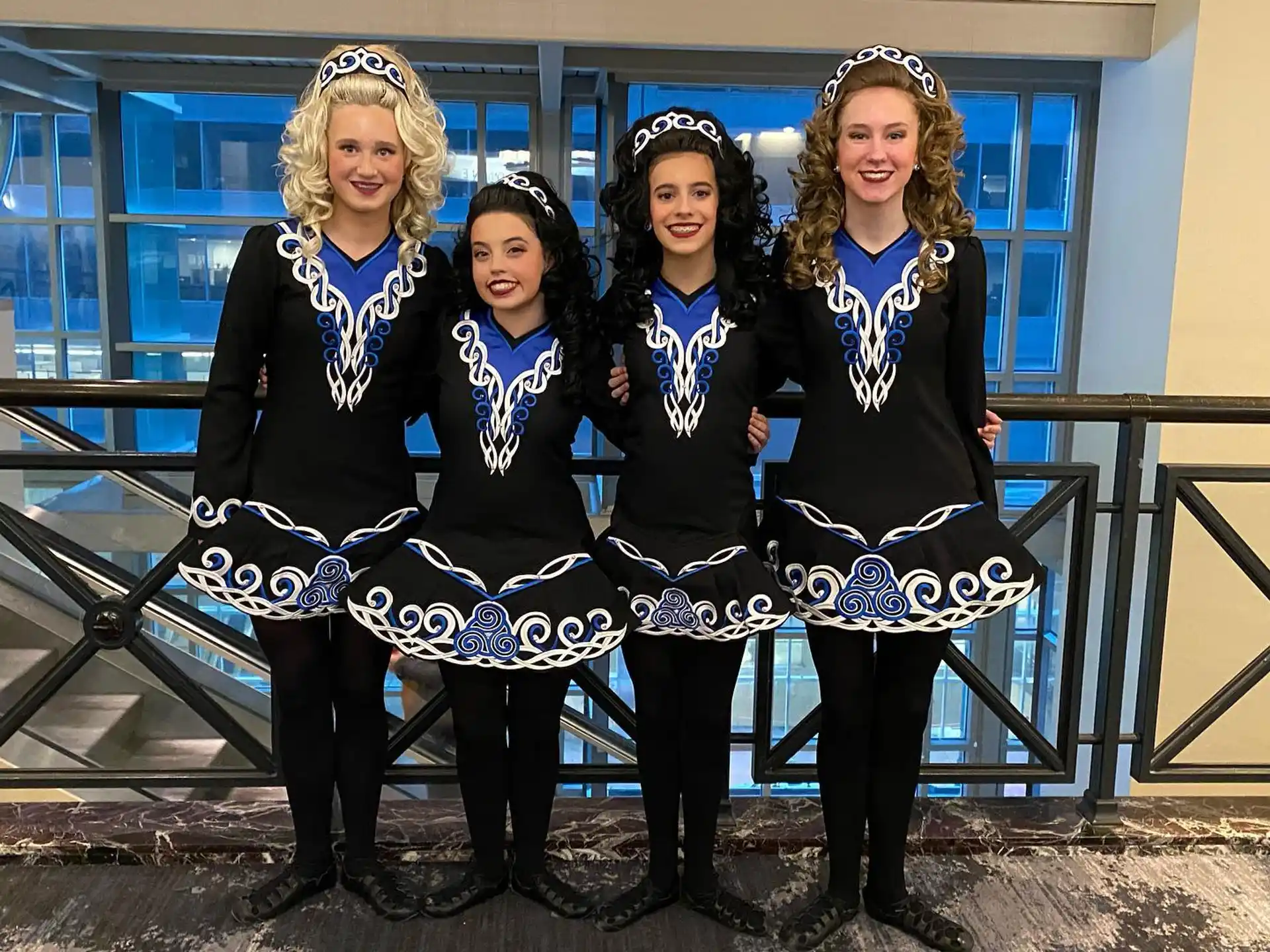 a group of women in black and white dresses