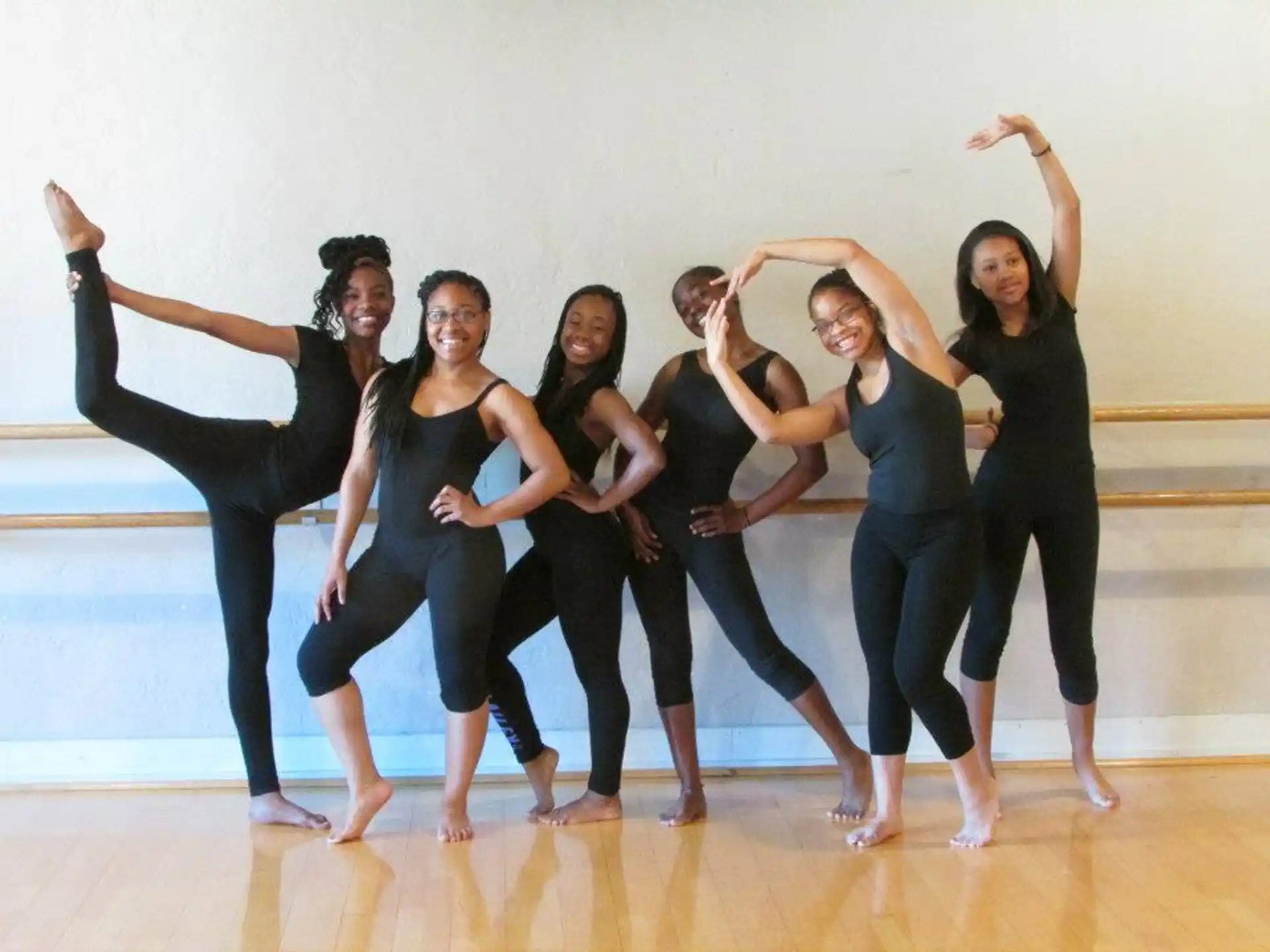 a group of women in black ballet outfits