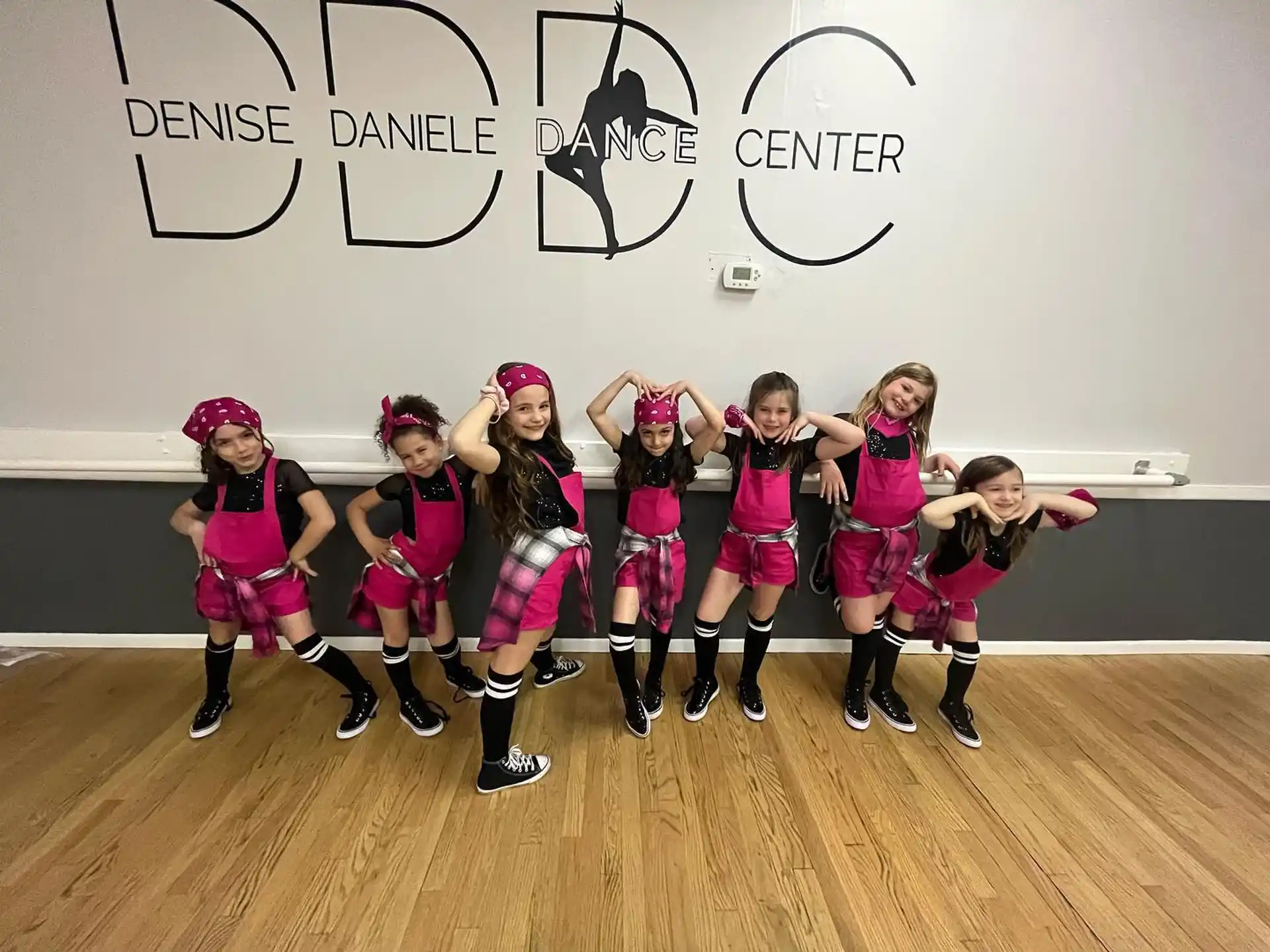 a group of girls in pink uniforms