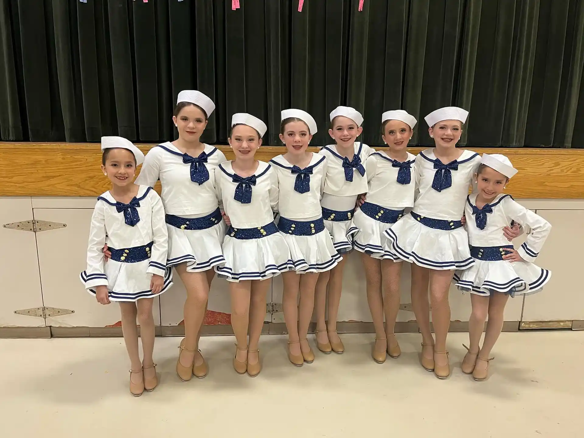 a group of women in white and blue uniforms
