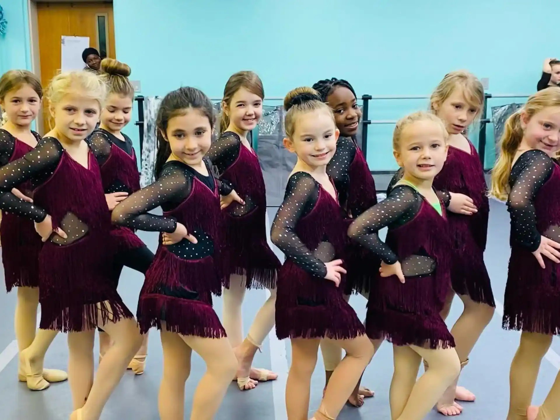 a group of girls in black and red dresses