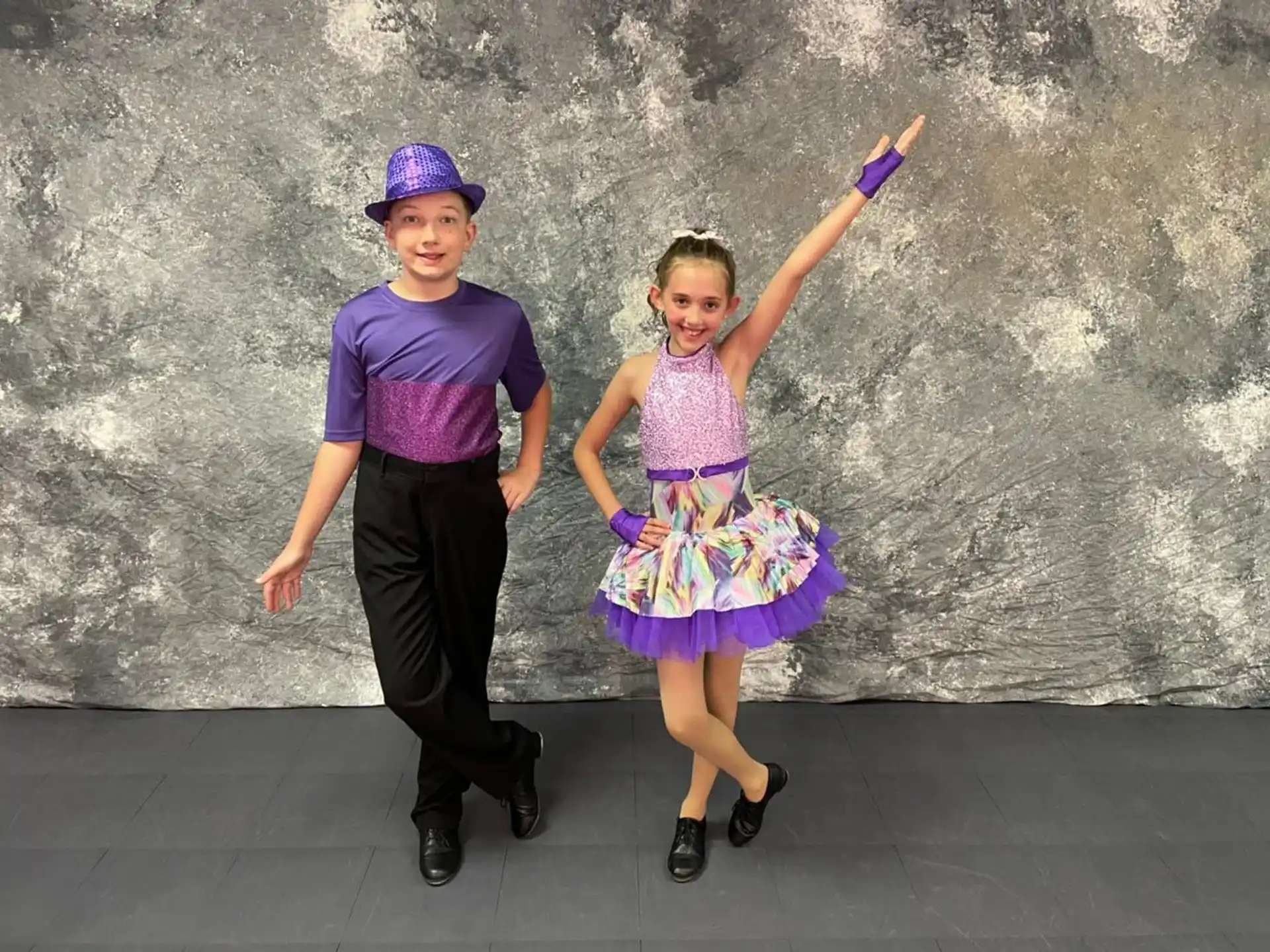 a boy and girl posing for a picture