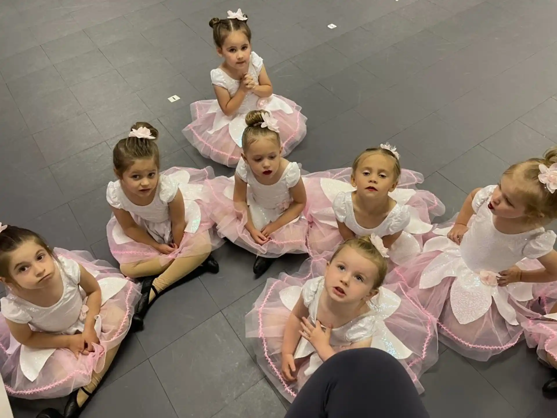 a group of girls in dresses
