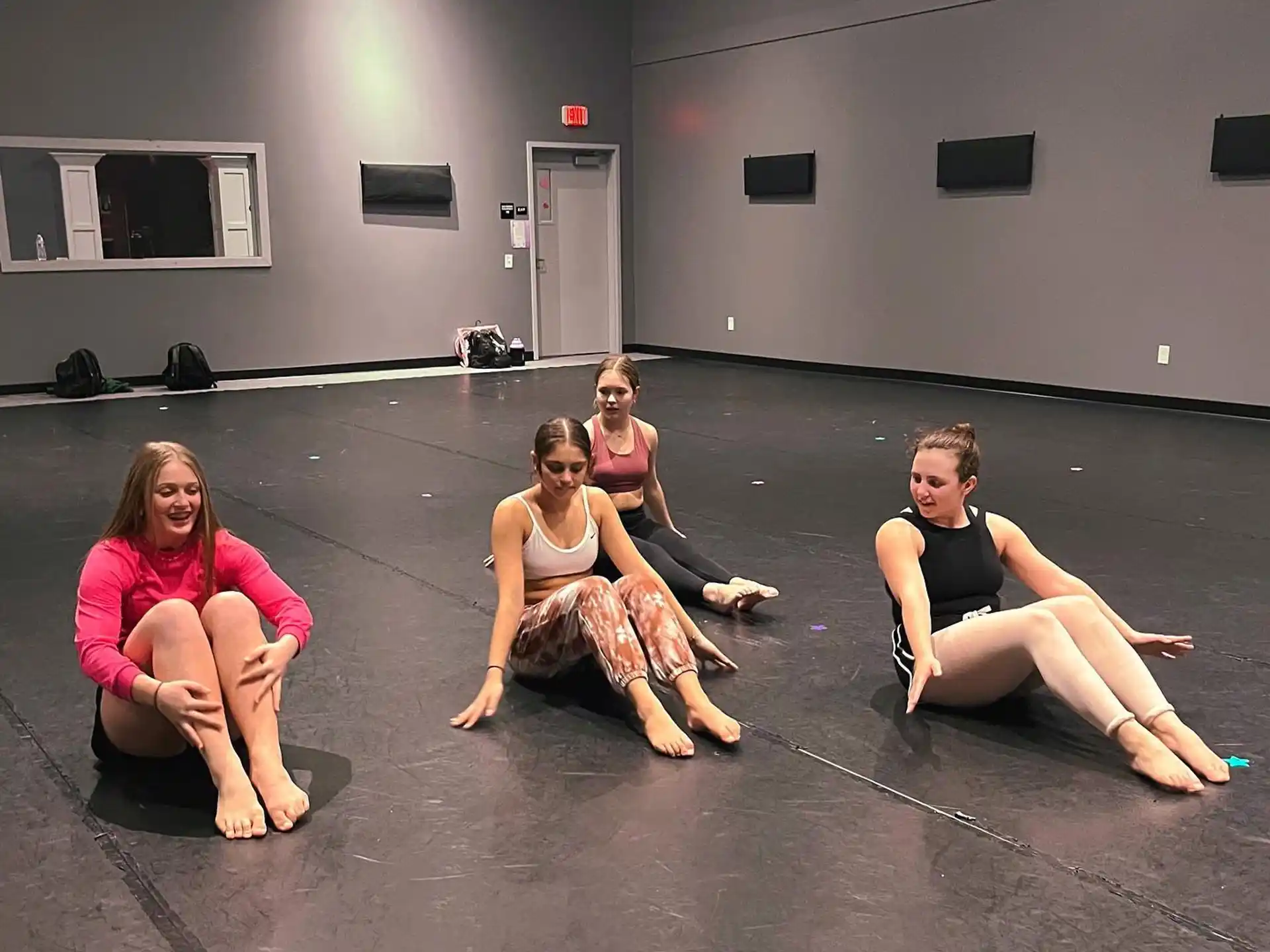 a group of women sitting on the floor