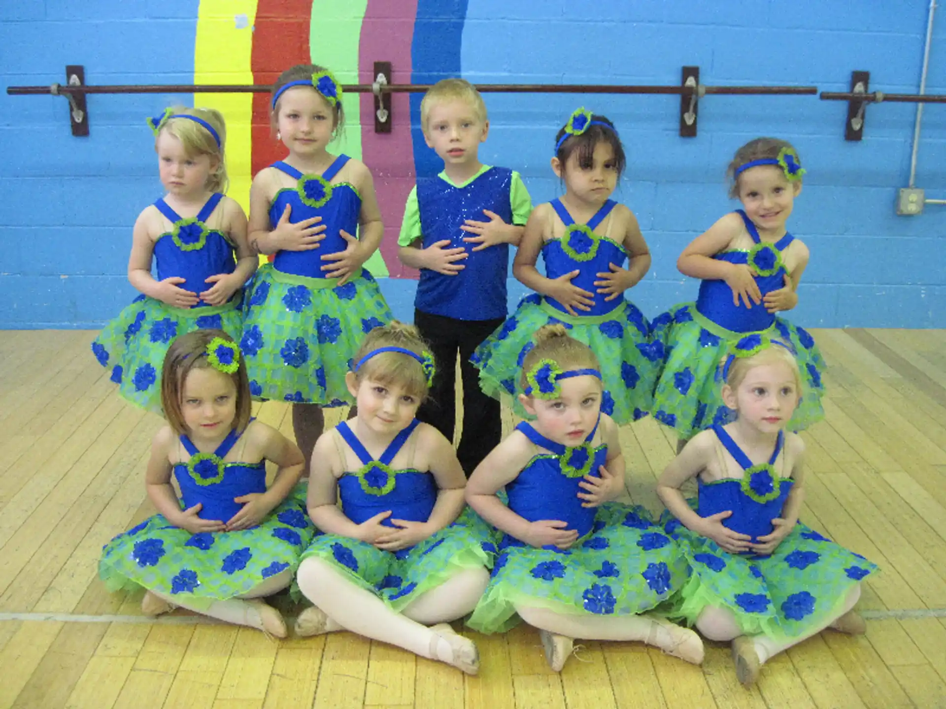a group of children in blue dresses