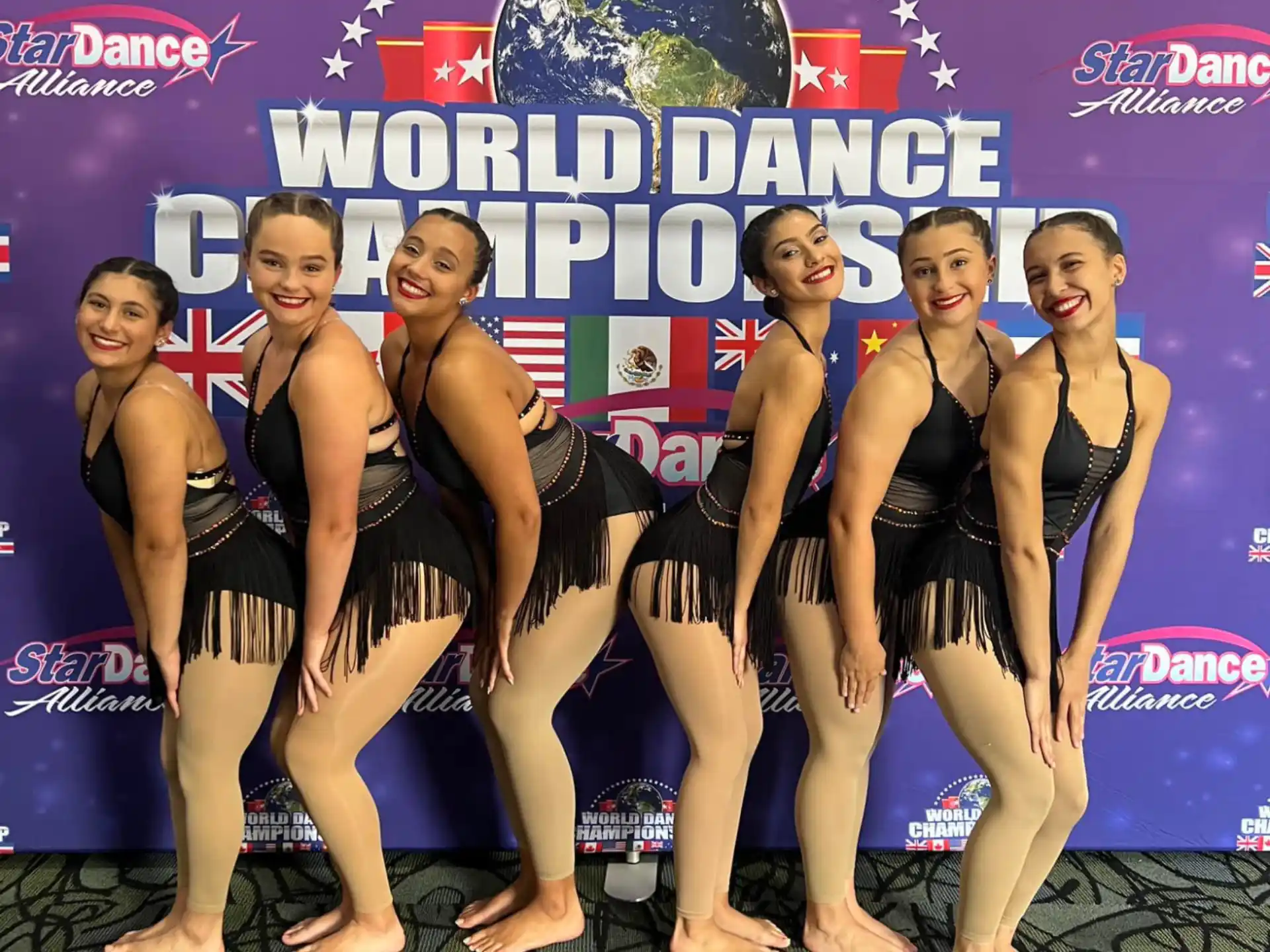 a group of women in swimsuits posing for a picture
