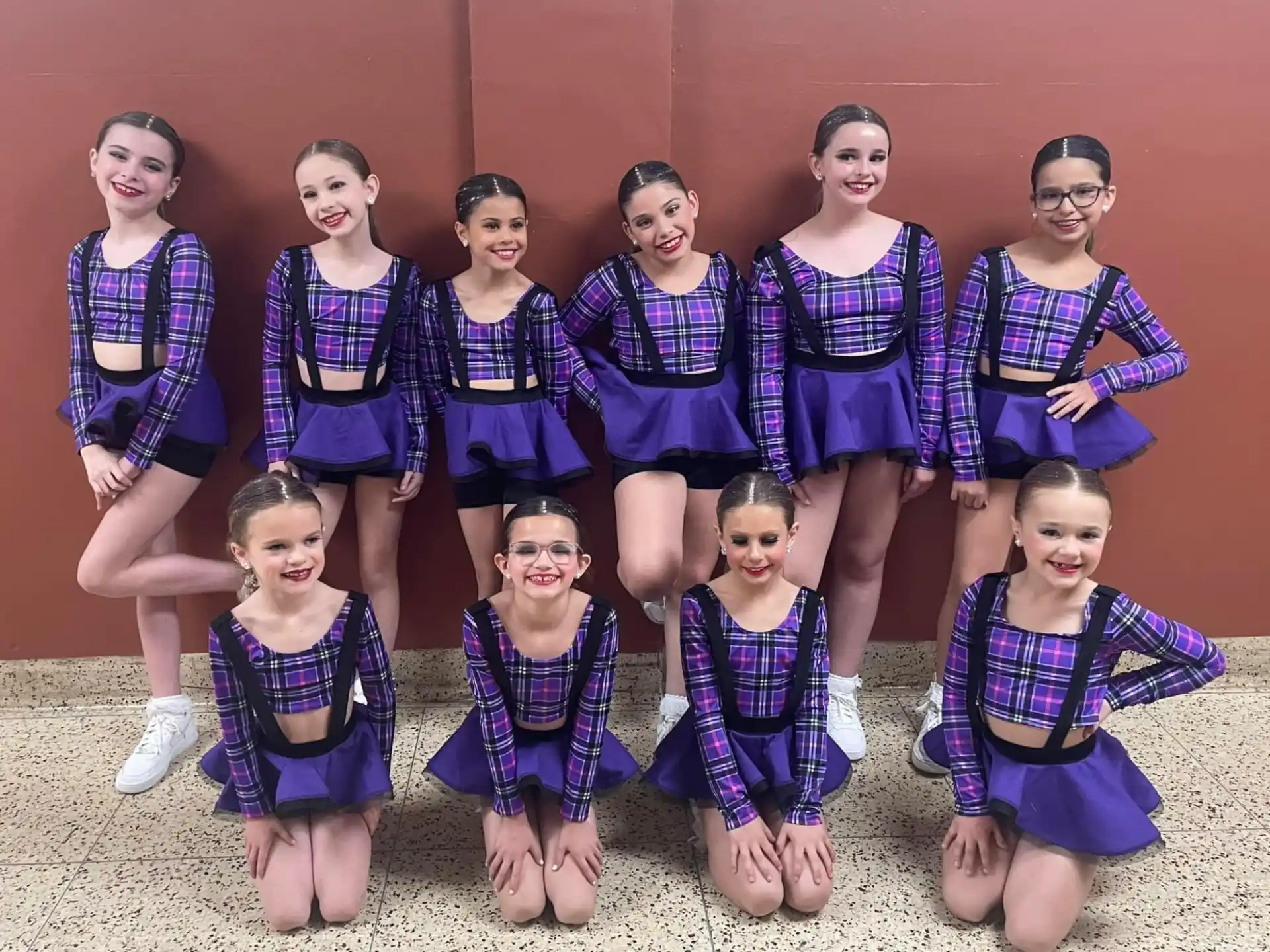 a group of girls in matching outfits