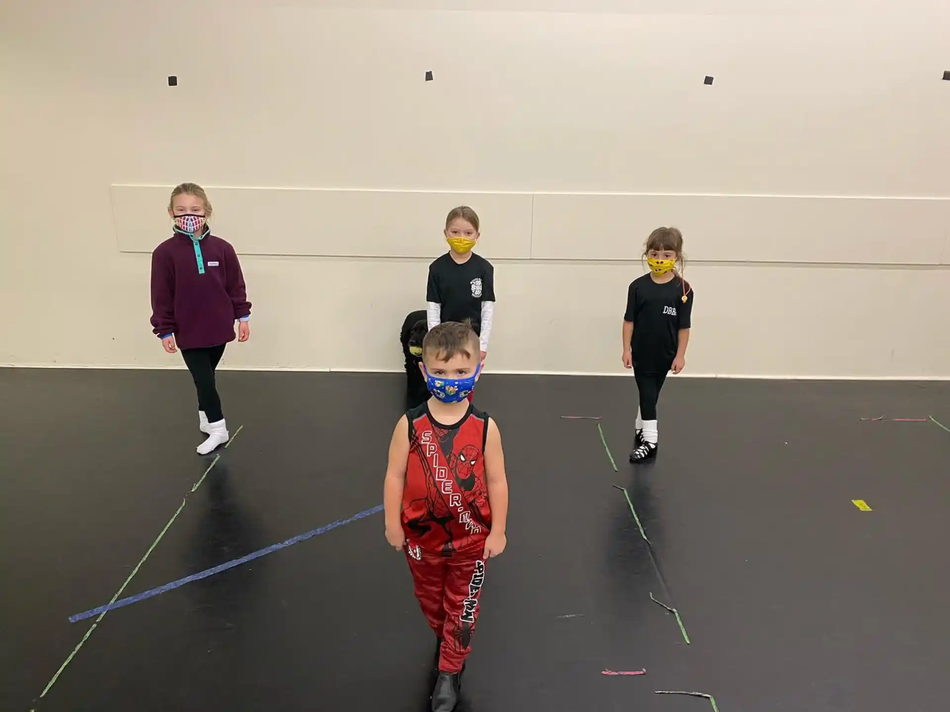 a group of kids wearing masks