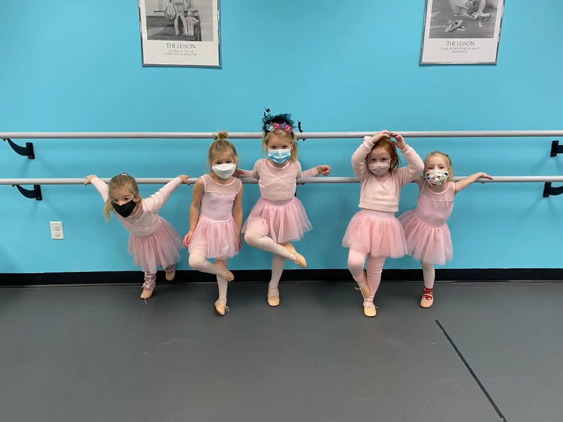 a group of girls in dresses dancing