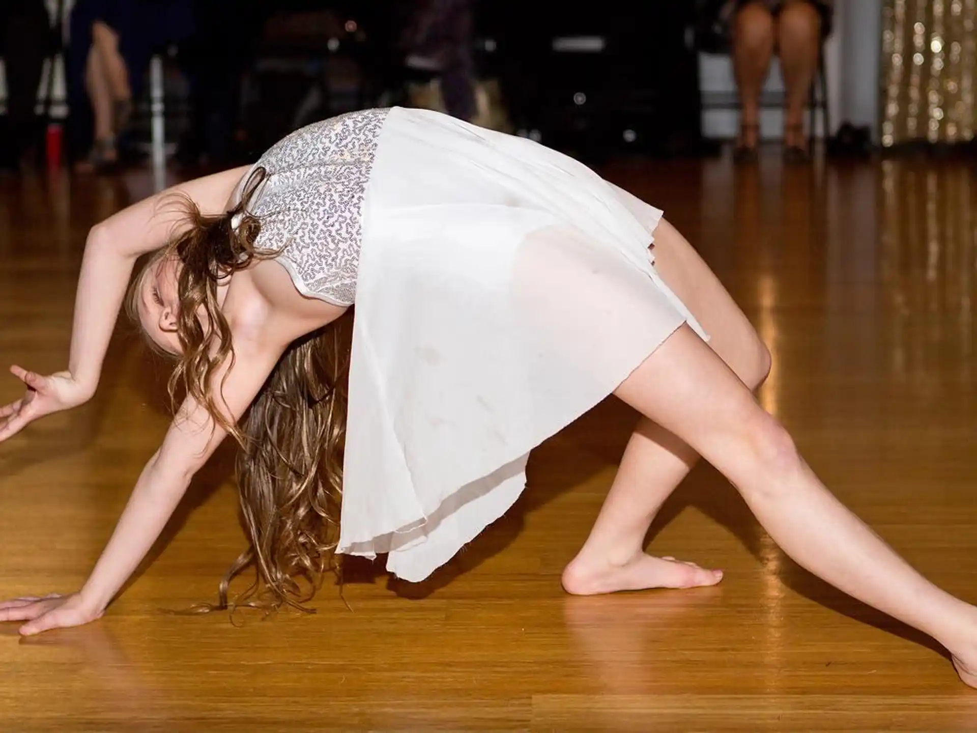 a woman doing a plank on a wood floor