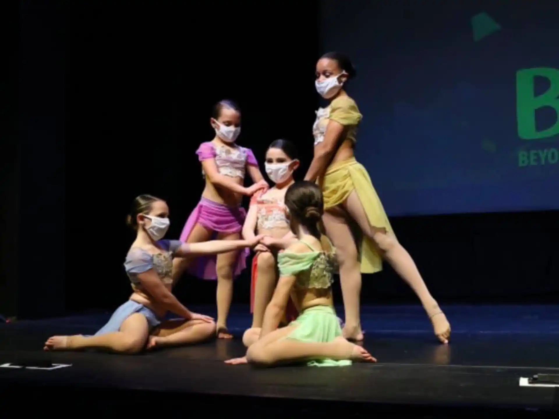 a group of people dancing on a stage