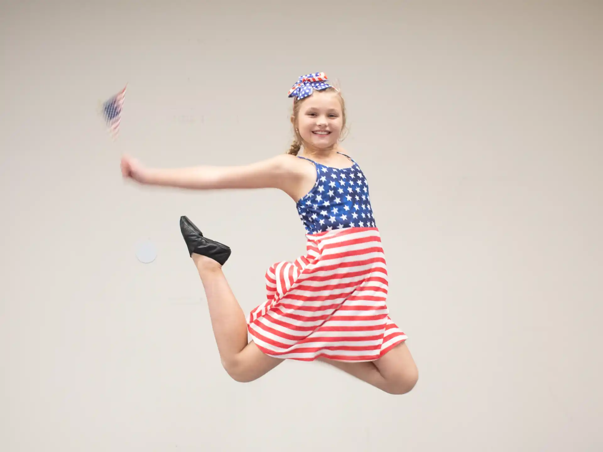 a girl in a dress jumping