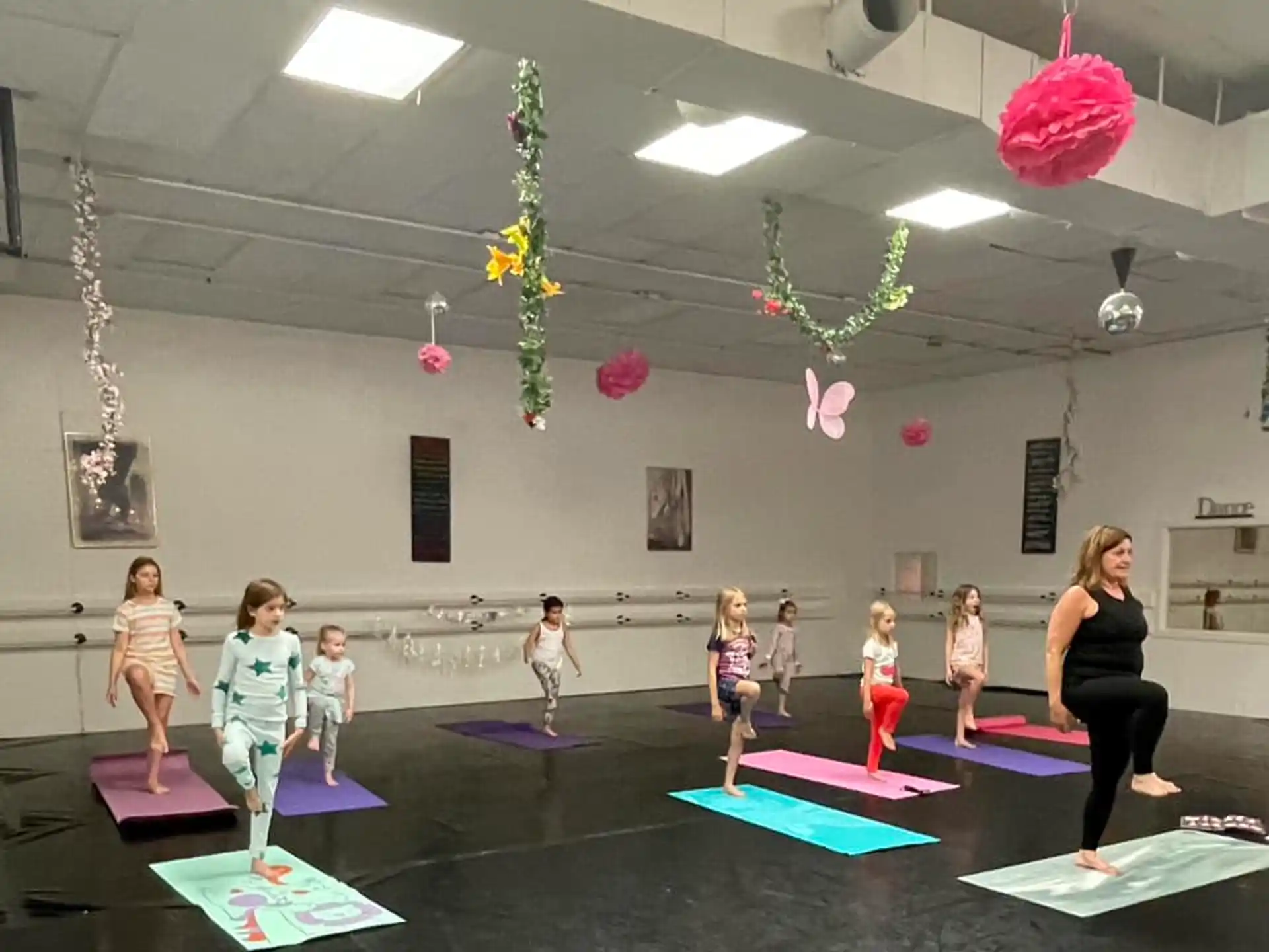 a group of children on mats in a room with lights