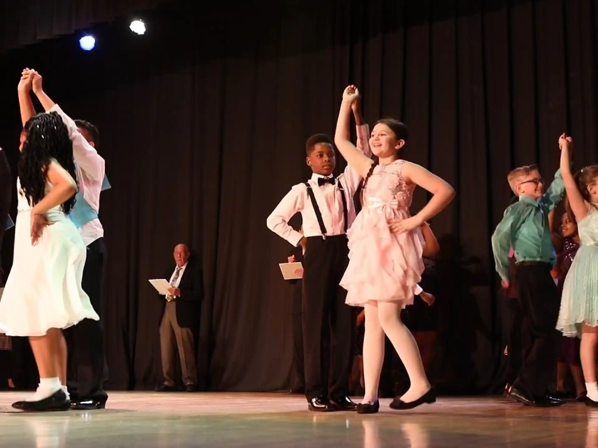 a group of people dancing on a stage
