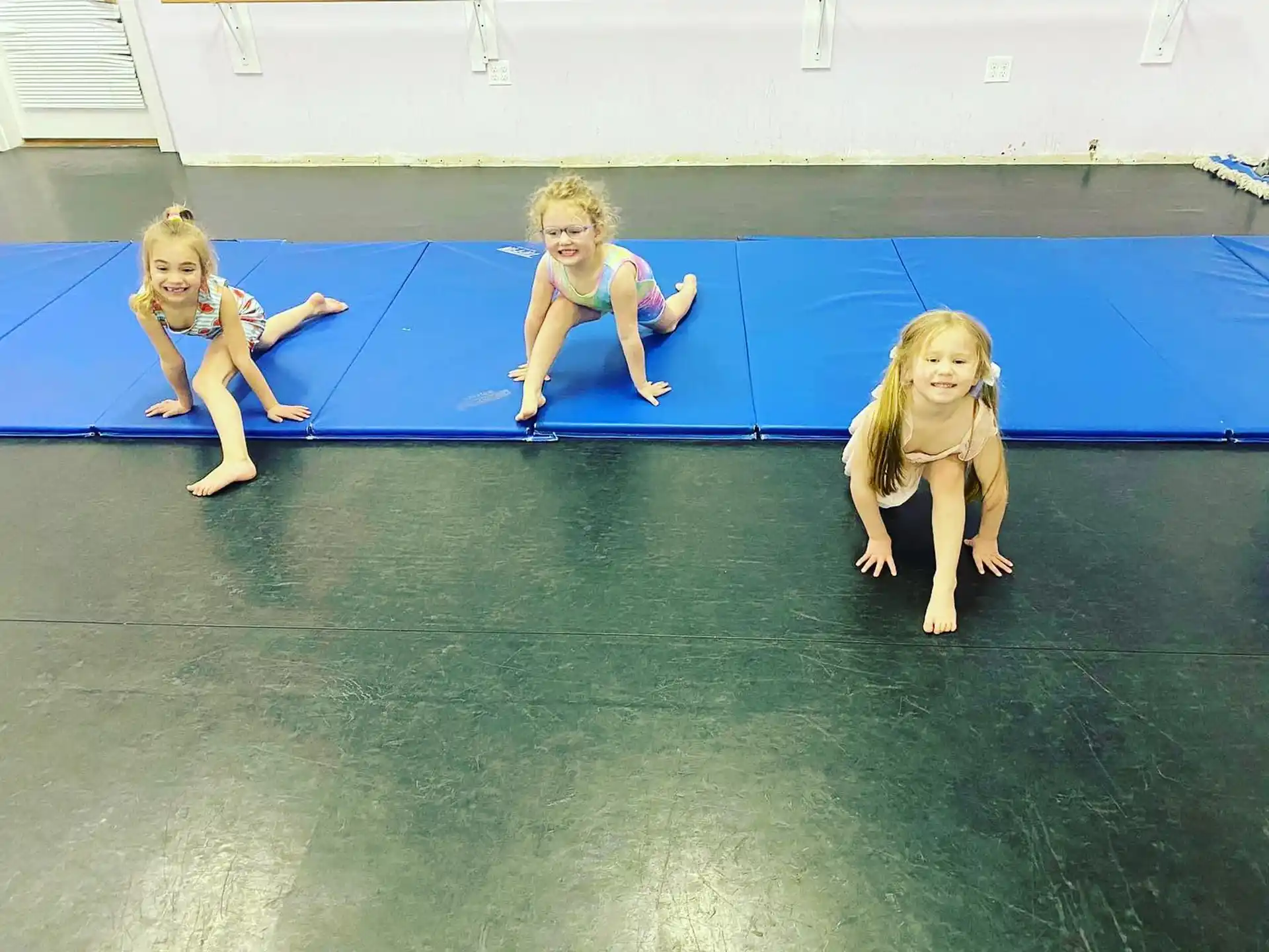 a group of people sitting on a blue mat