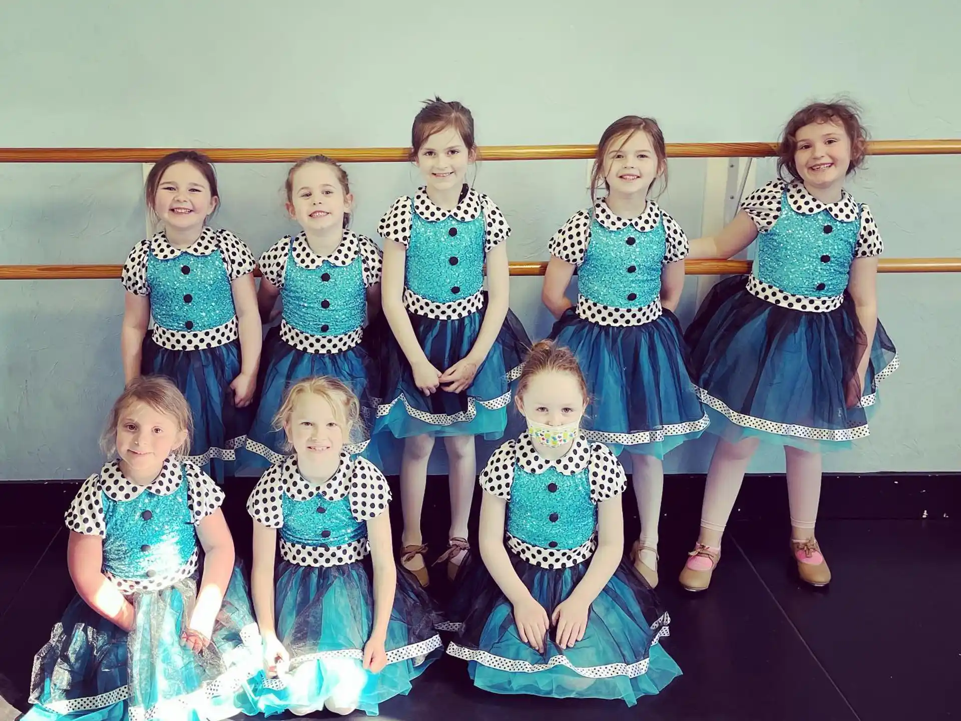 a group of women in dresses