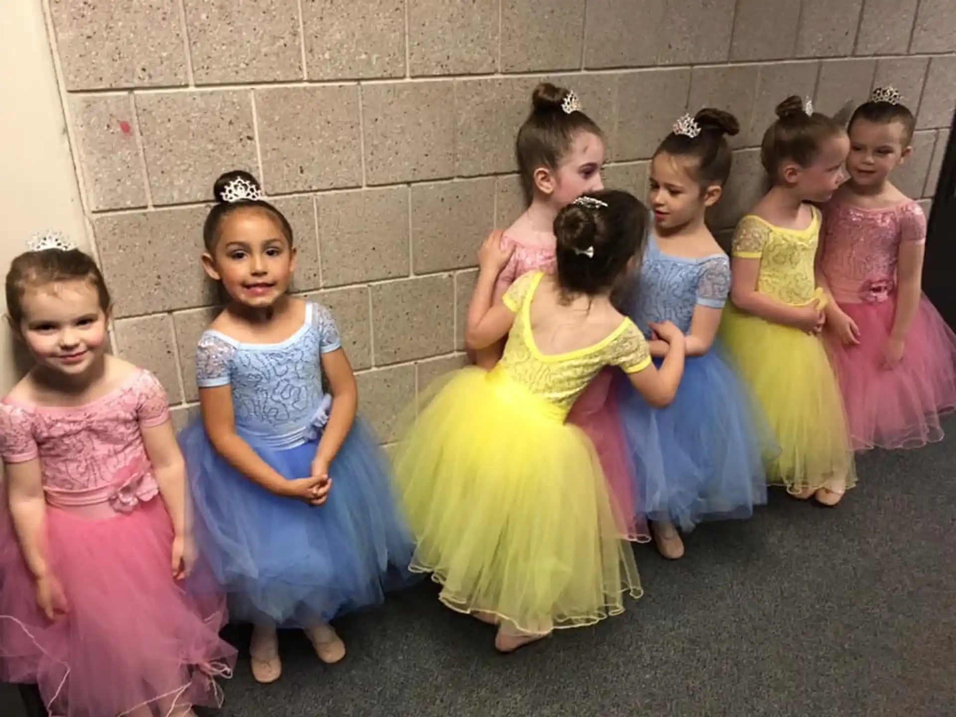 a group of girls in dresses