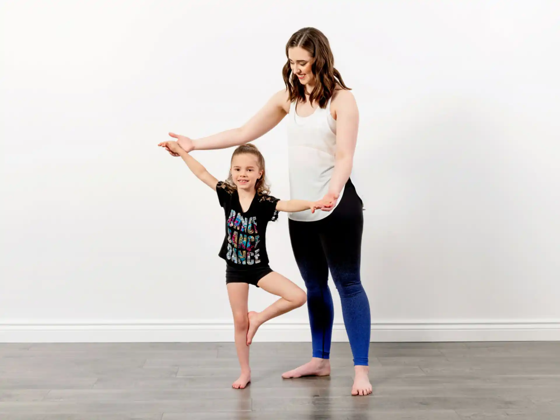 a woman and a girl dancing
