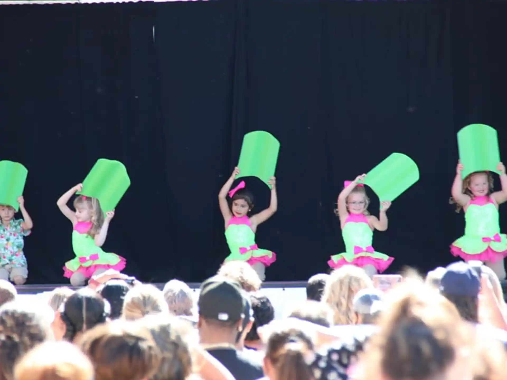 a group of children in clothing on a stage
