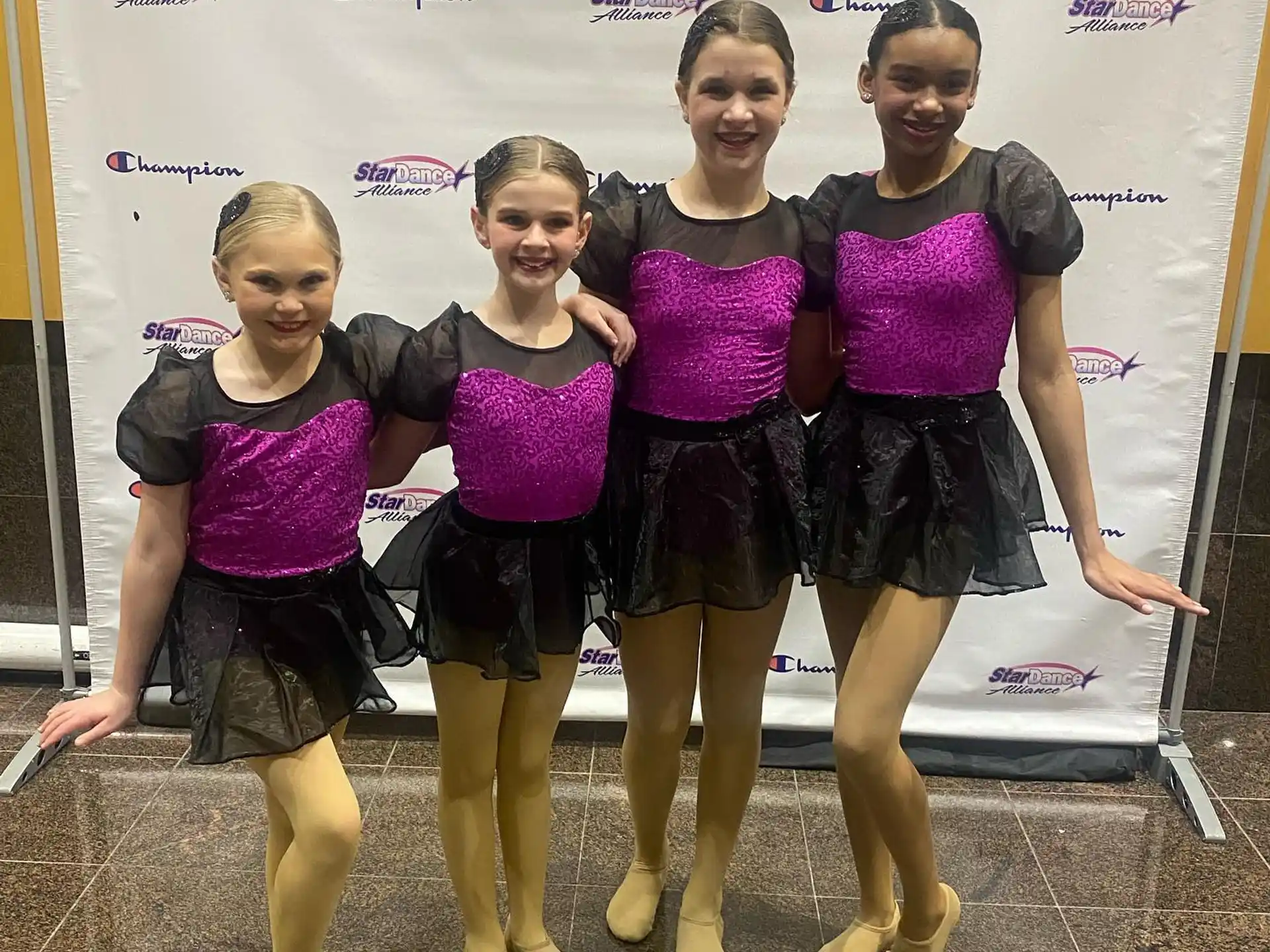 a group of girls in matching outfits