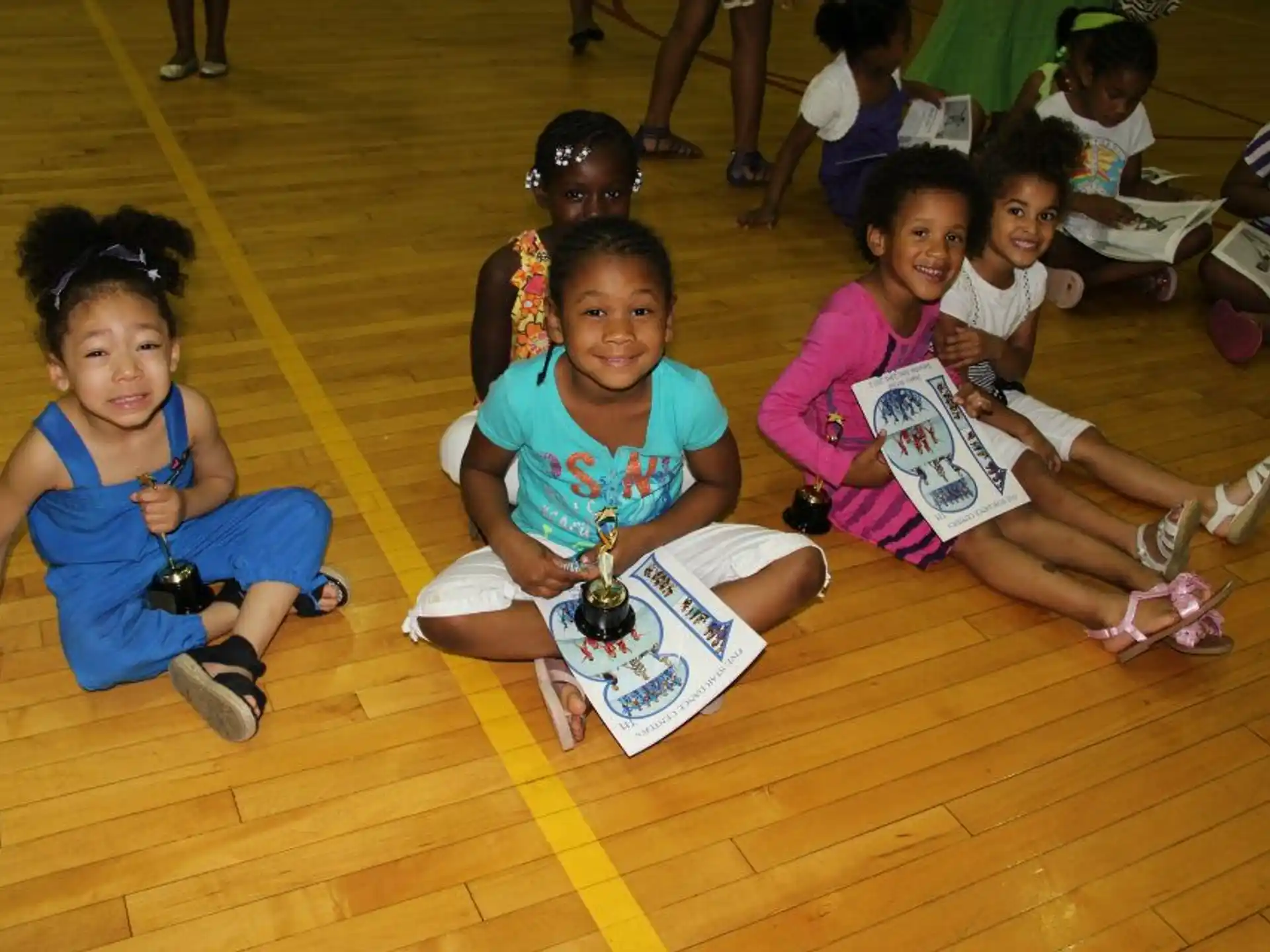 a group of children sitting on the floor reading books