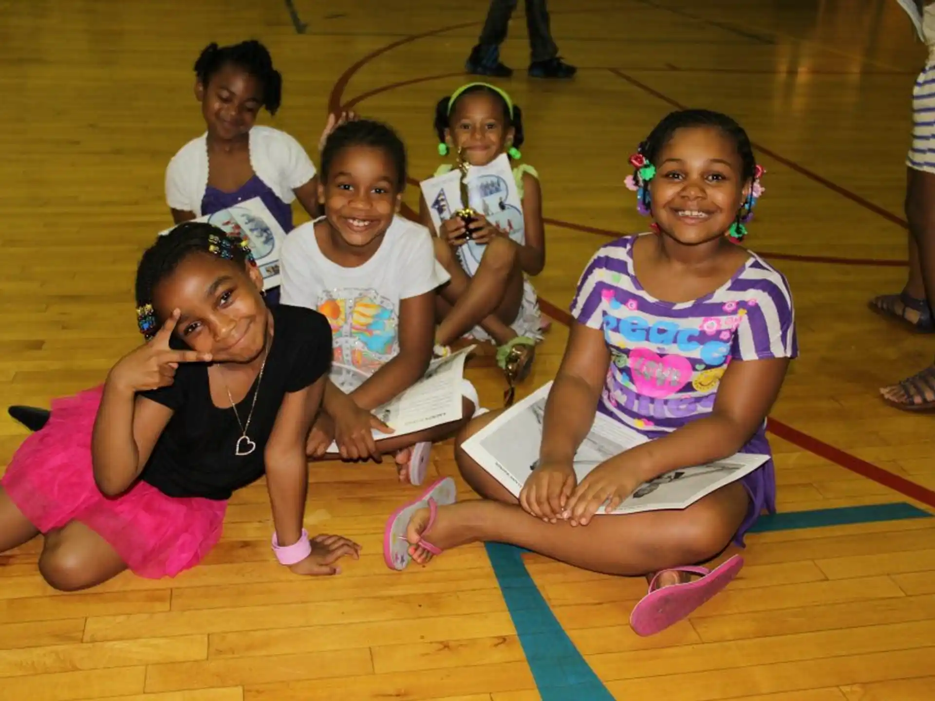 a group of girls sitting on the floor