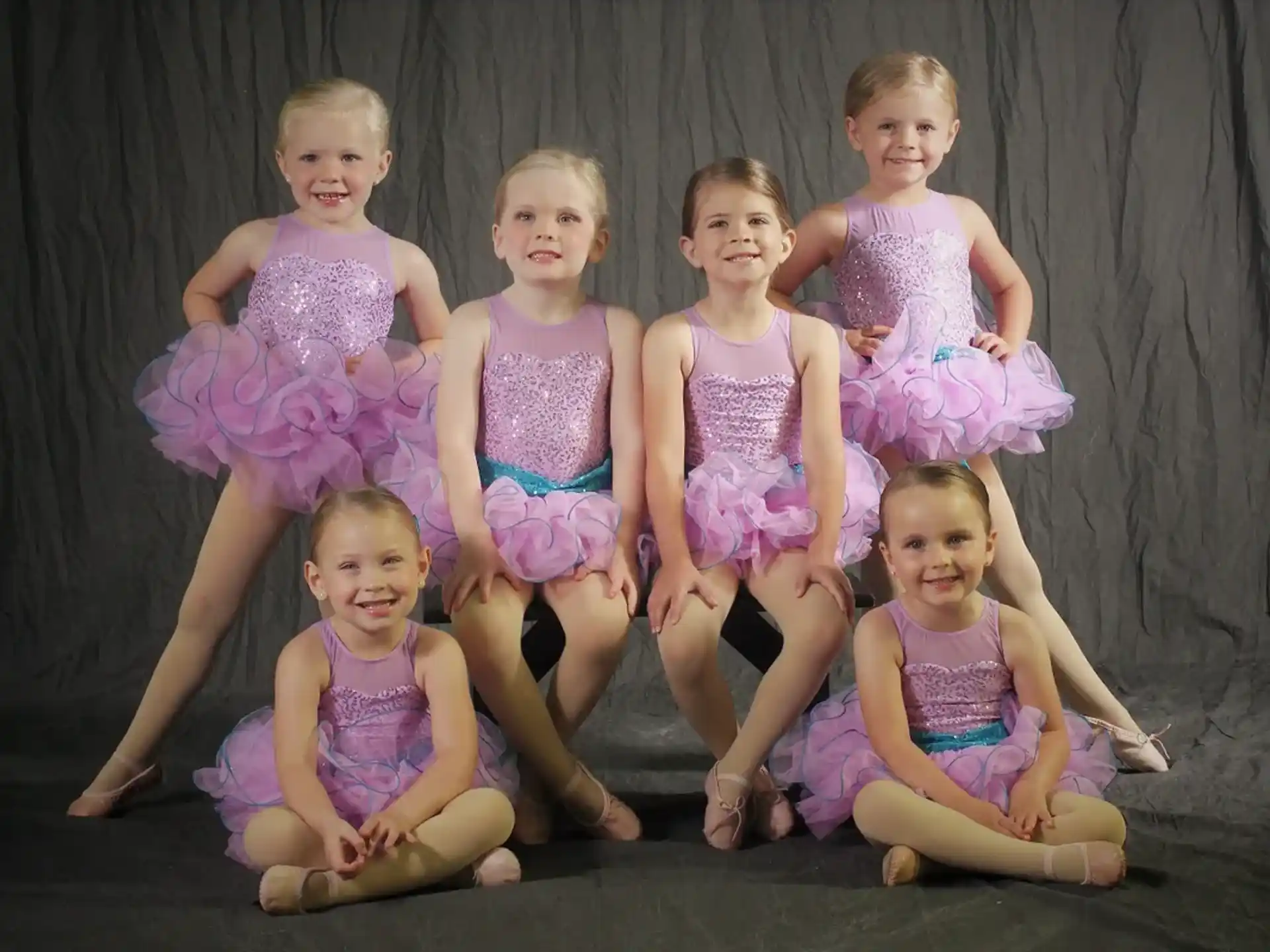 a group of girls in swimsuits posing for a photo