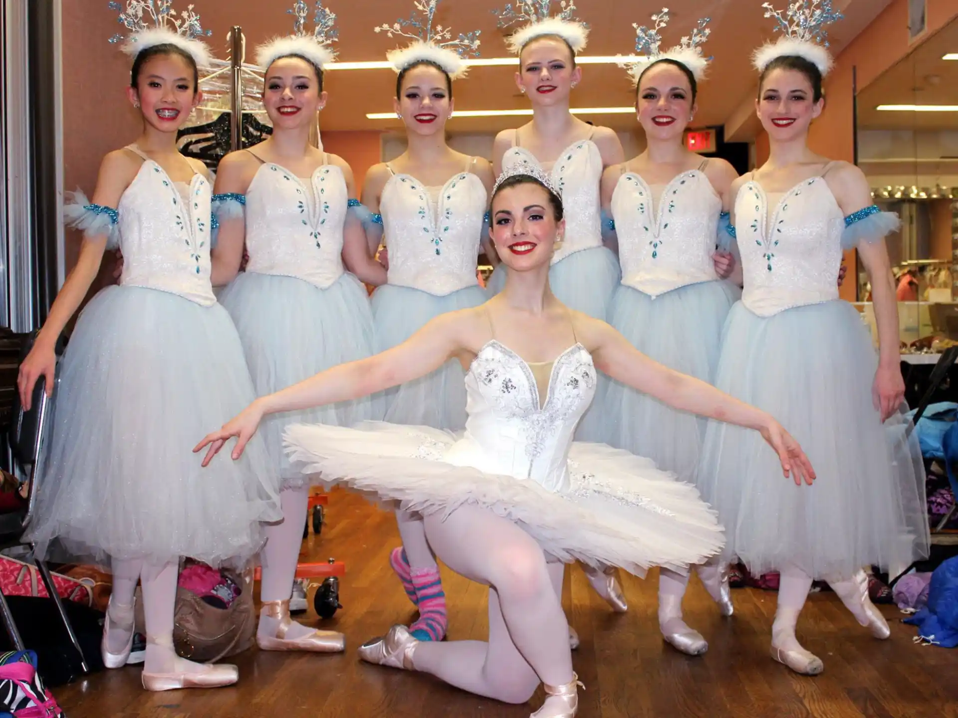 a group of women in white dresses