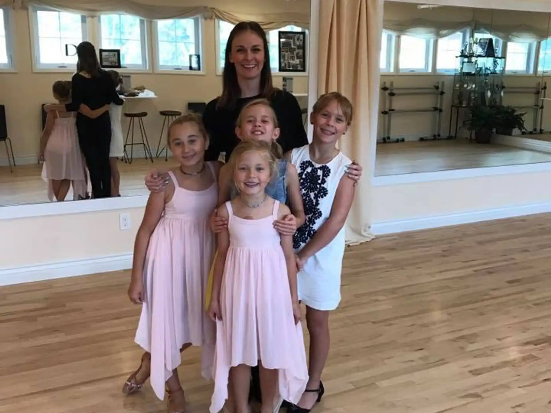 a group of girls in dresses