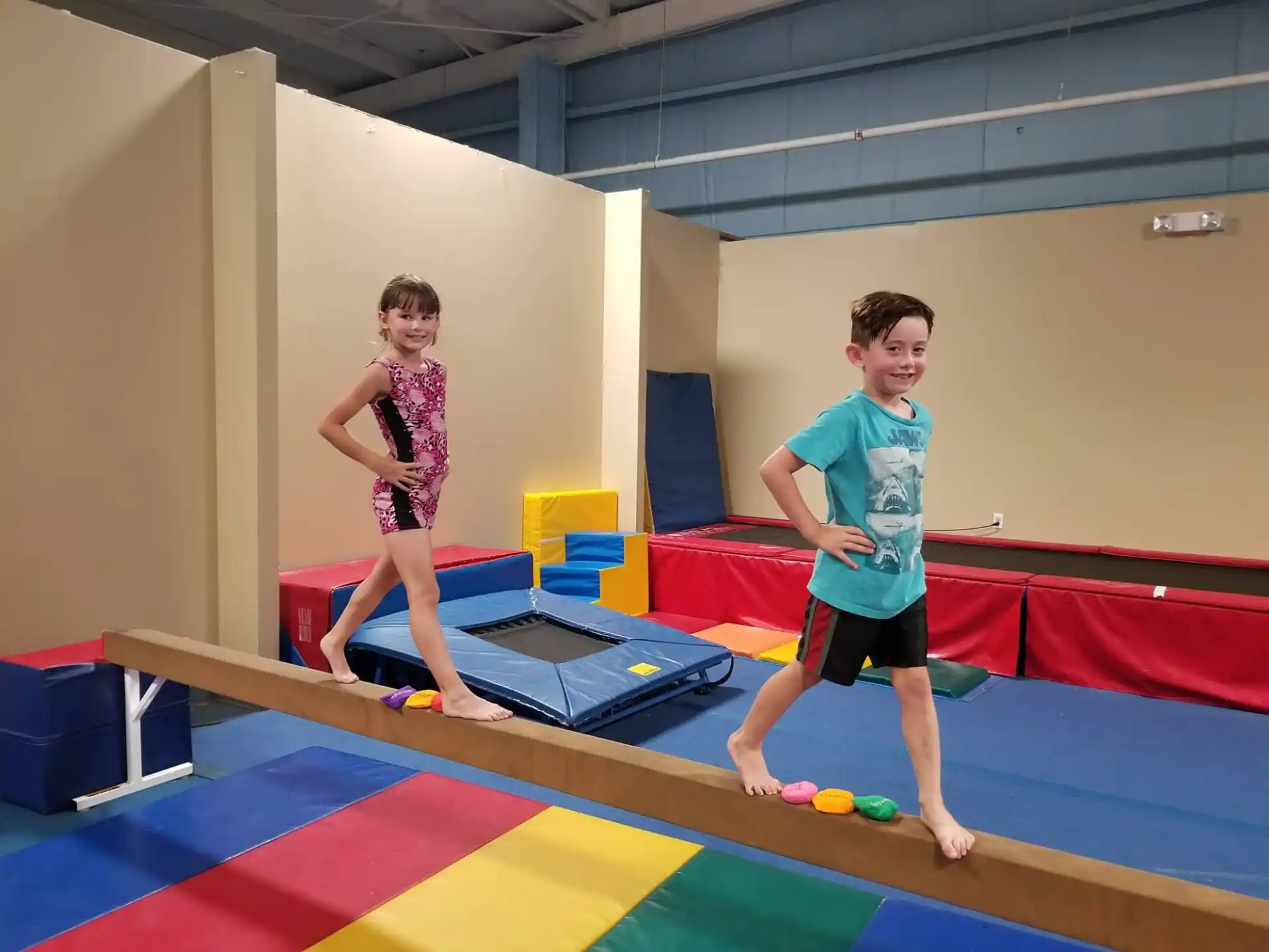 a boy and girl on a mat