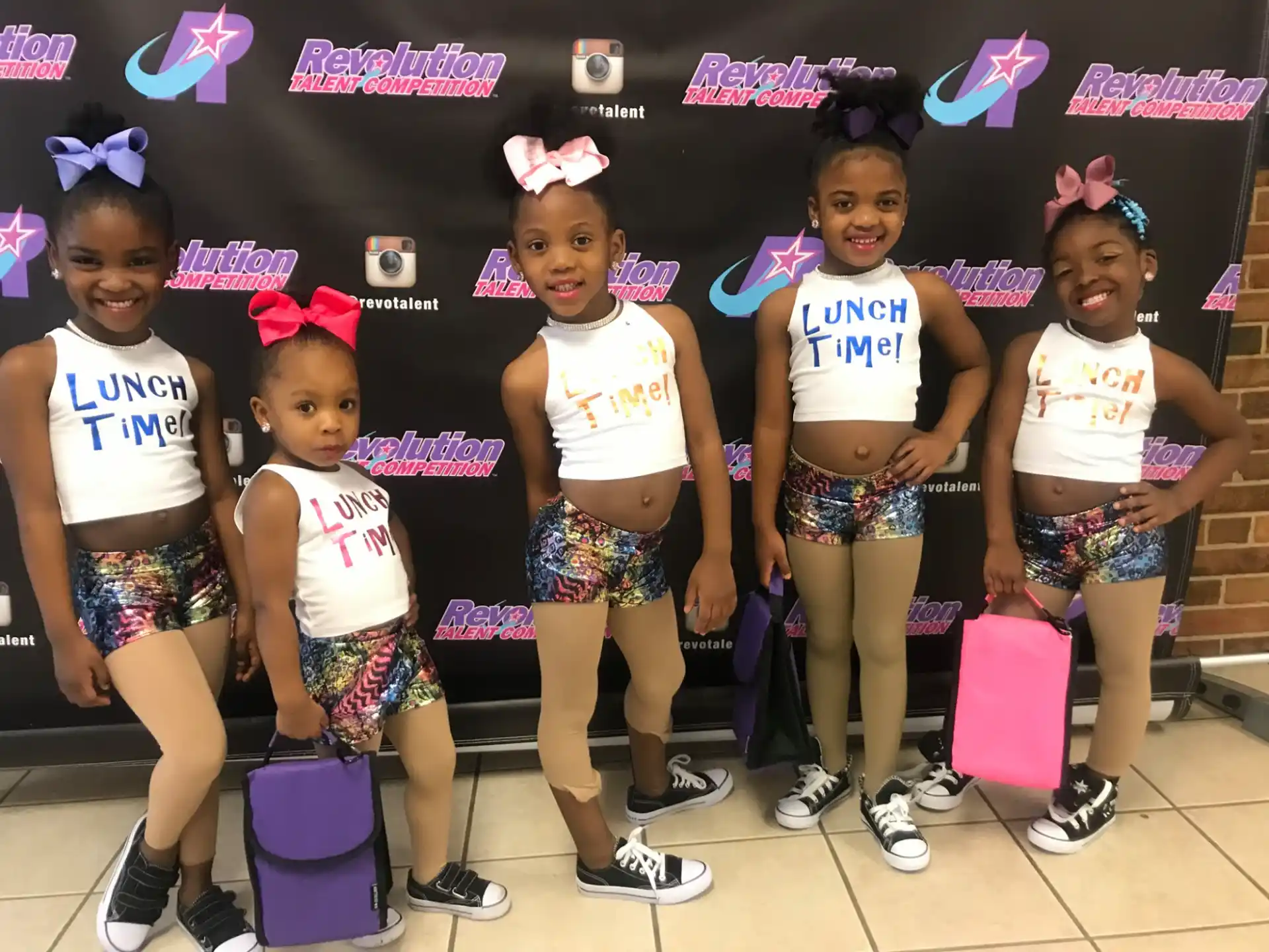 a group of girls wearing matching outfits