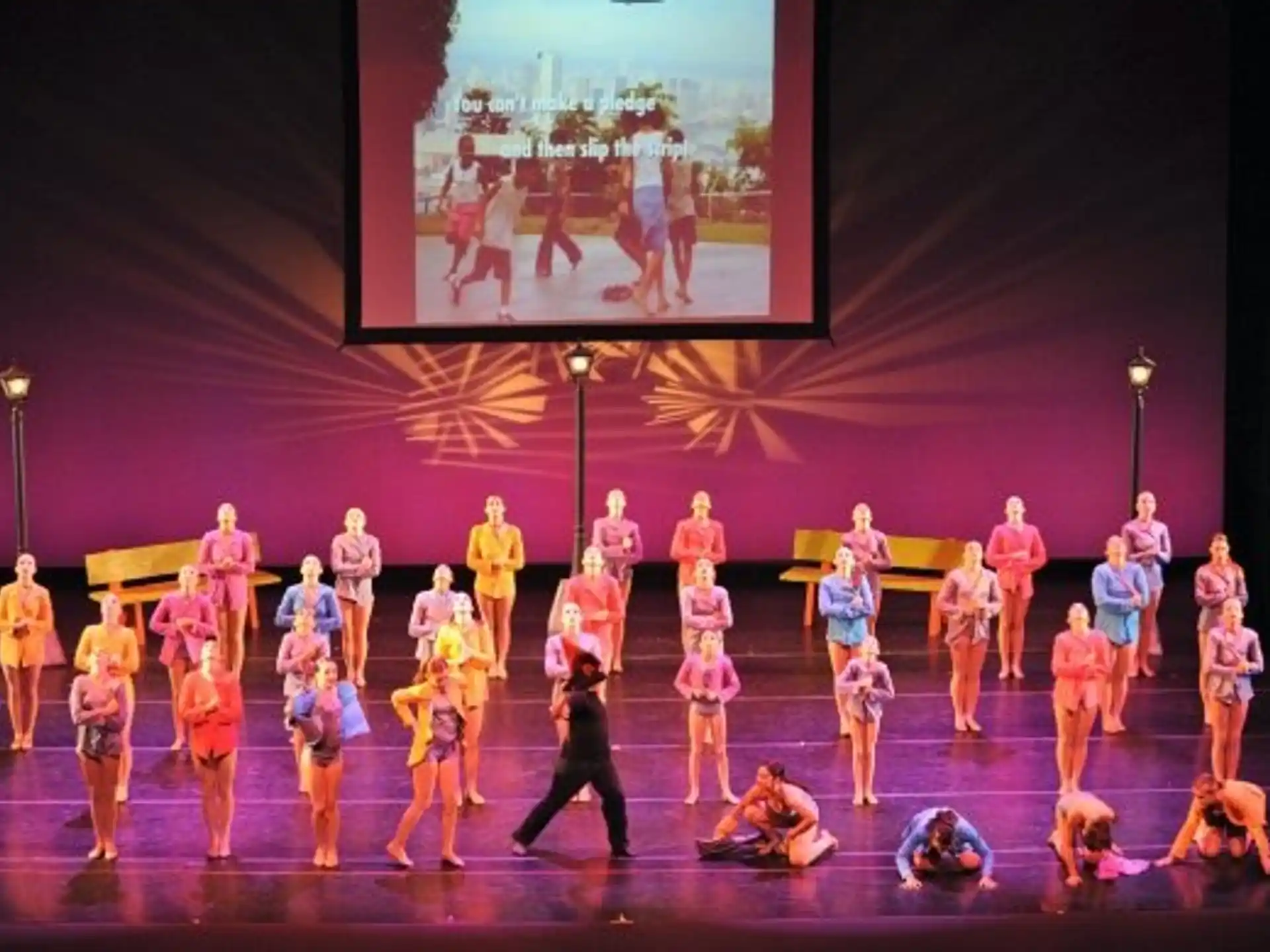 a group of people dancing on a stage