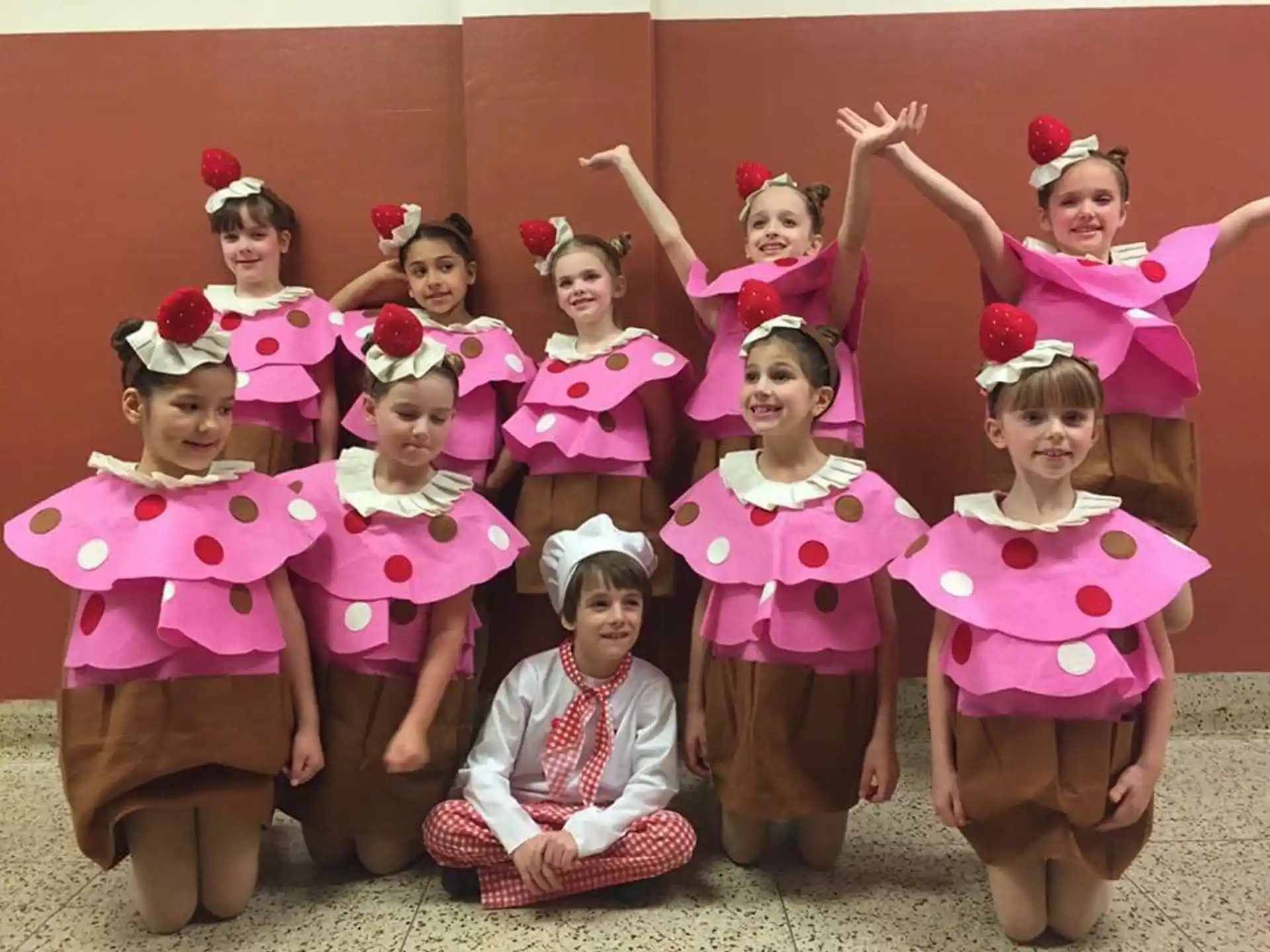 a group of girls in pink dresses