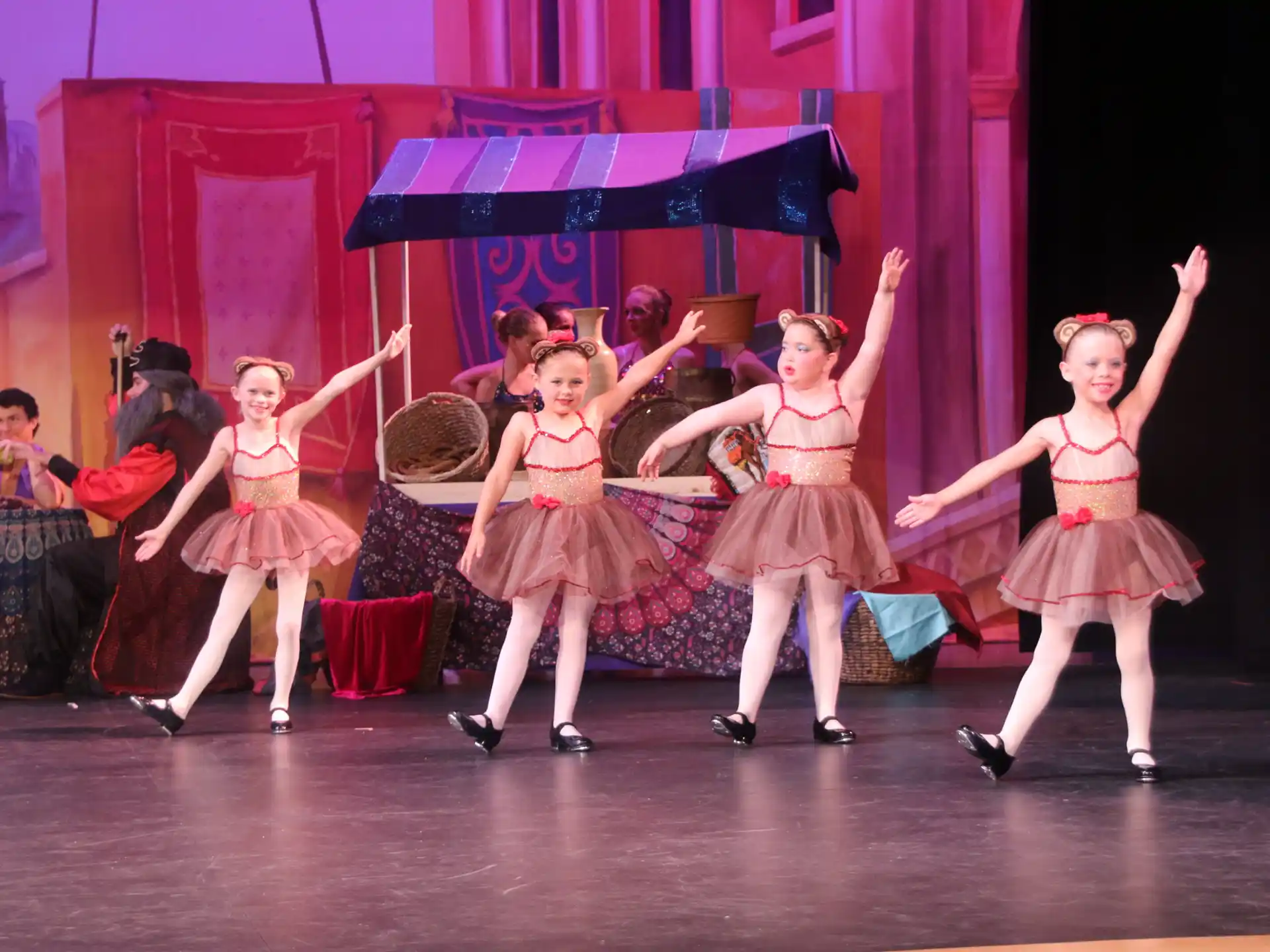 a group of girls dancing on a stage