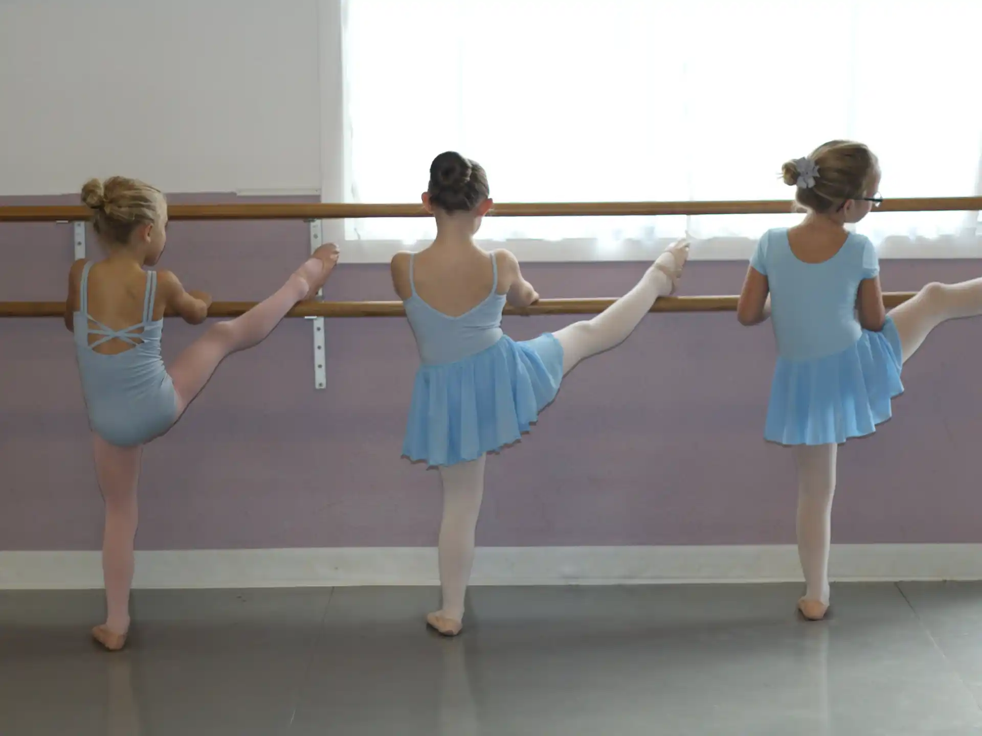 a group of girls in blue dresses