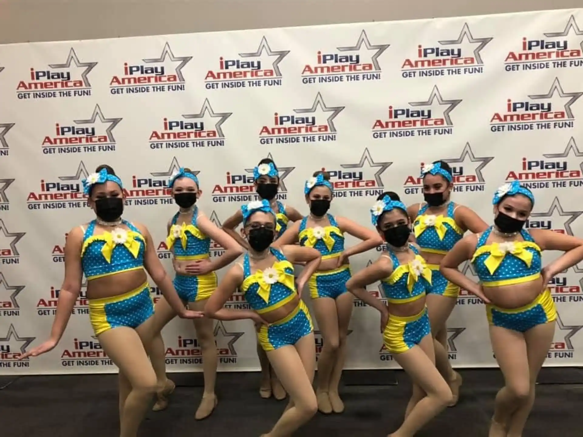 a group of women in yellow swimsuits running on a track