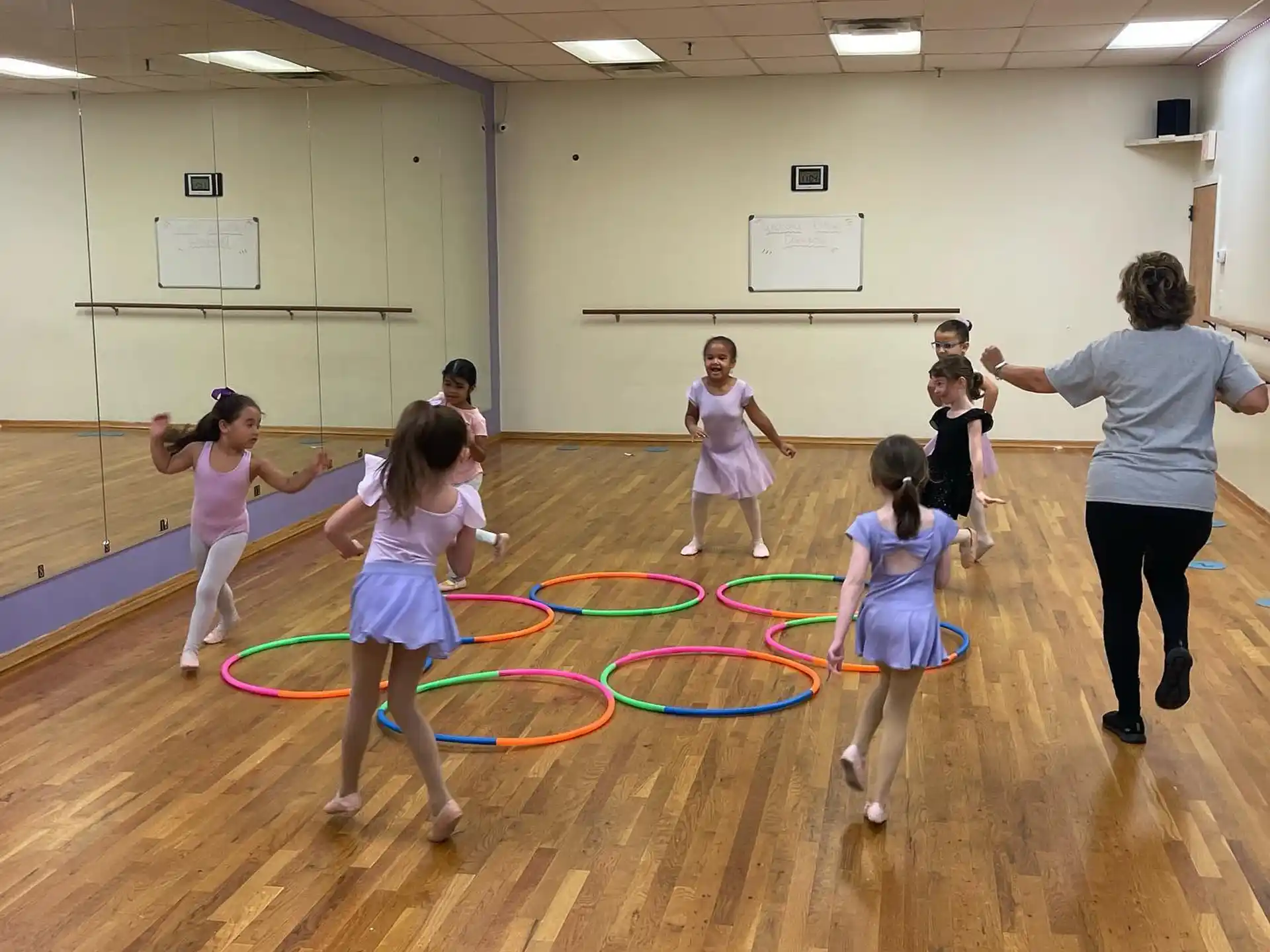 a group of children playing on a mat in a gymnasium