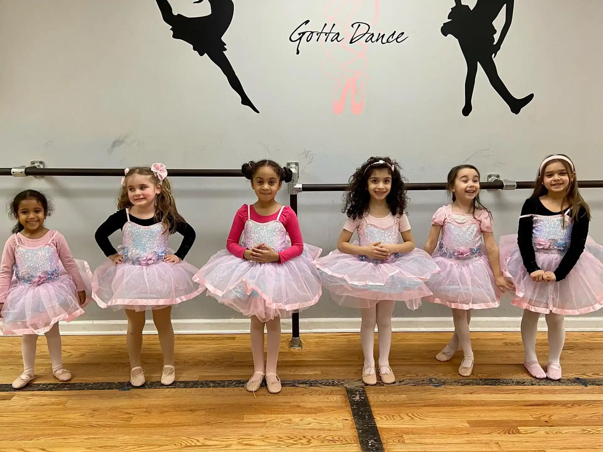 a group of girls in dresses