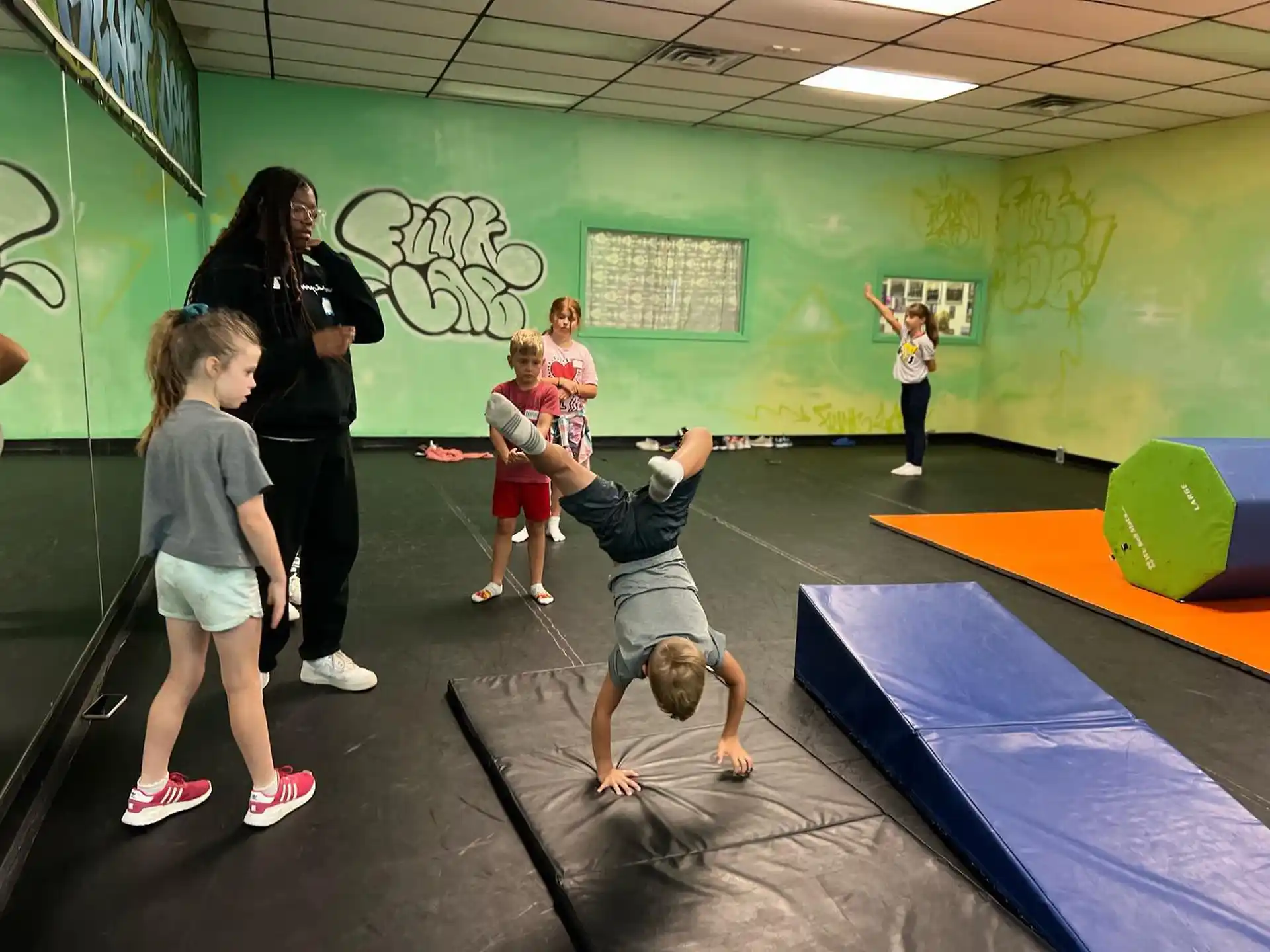 a group of children playing on a mat in a classroom