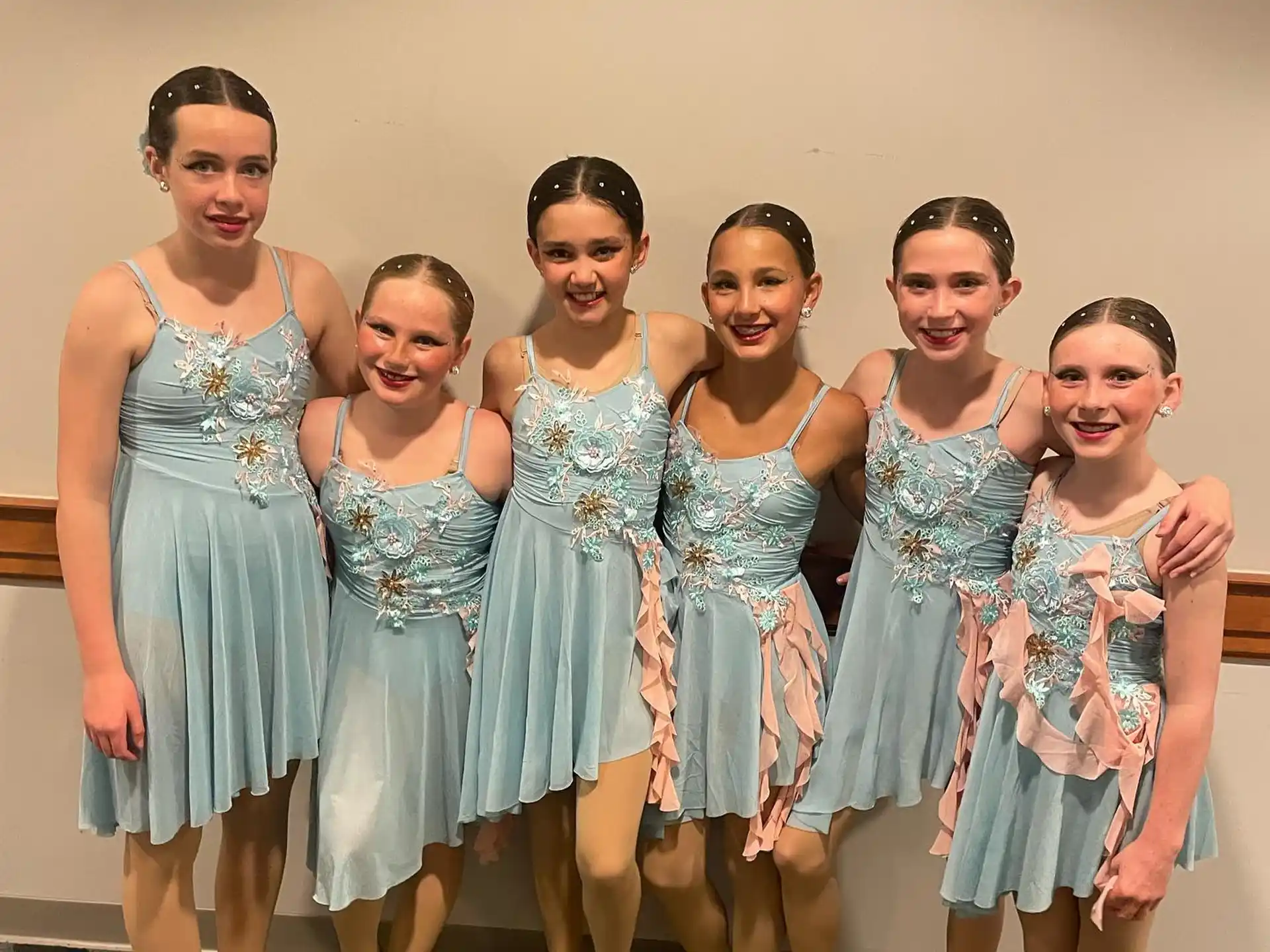a group of women in dresses