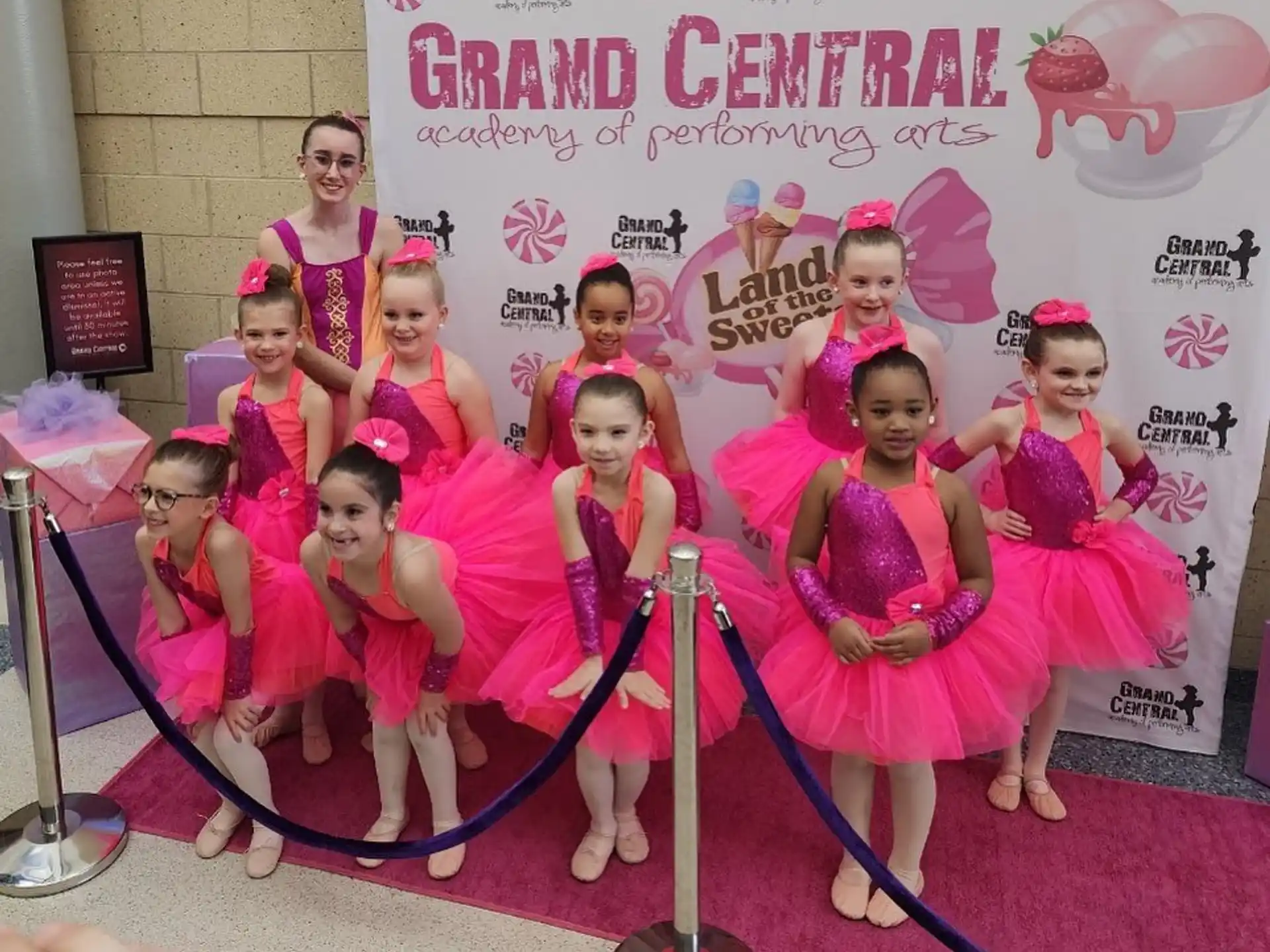 a group of girls in pink dresses