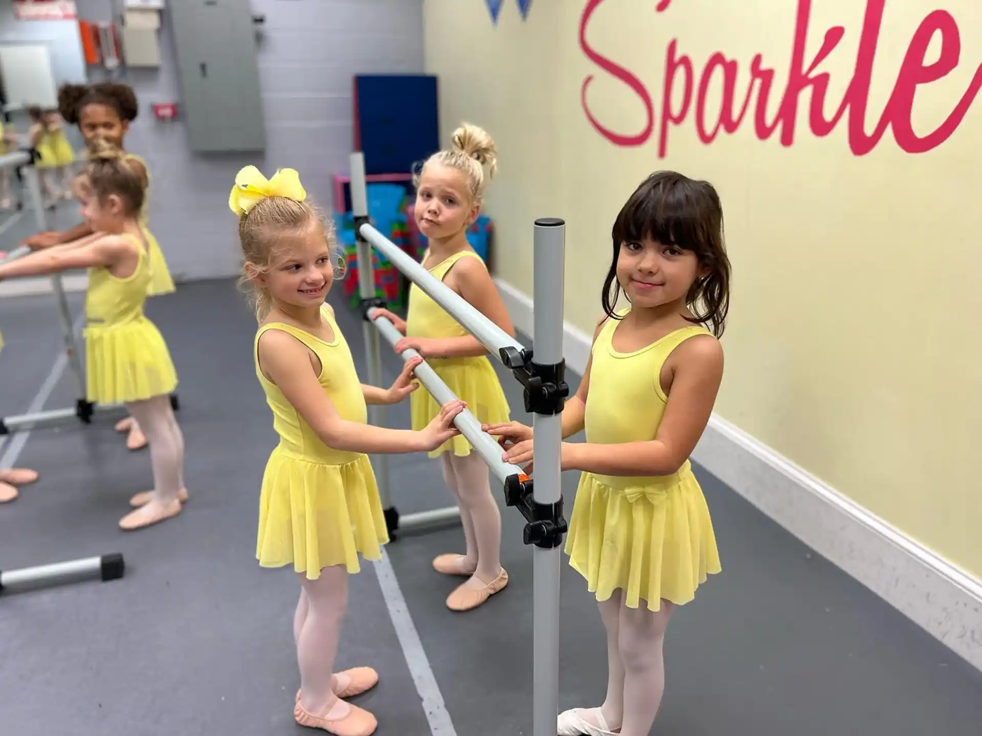 a group of girls in yellow dresses