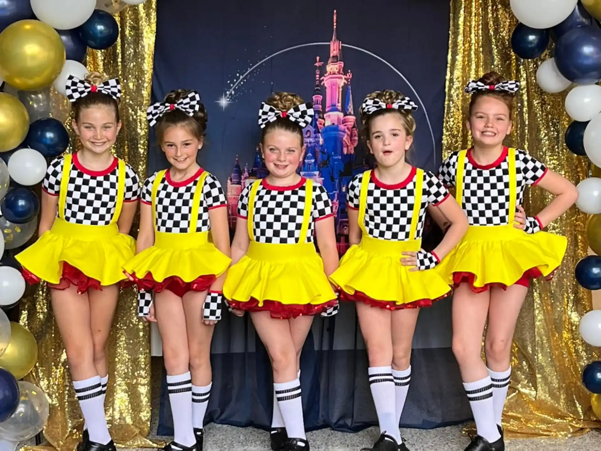 a group of girls in yellow uniforms