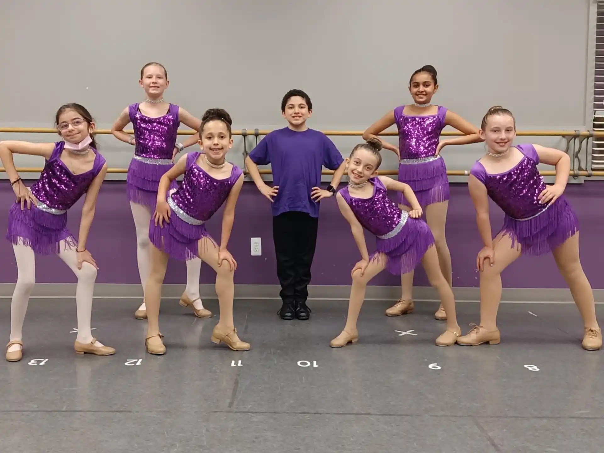 a group of people in purple and white dancing