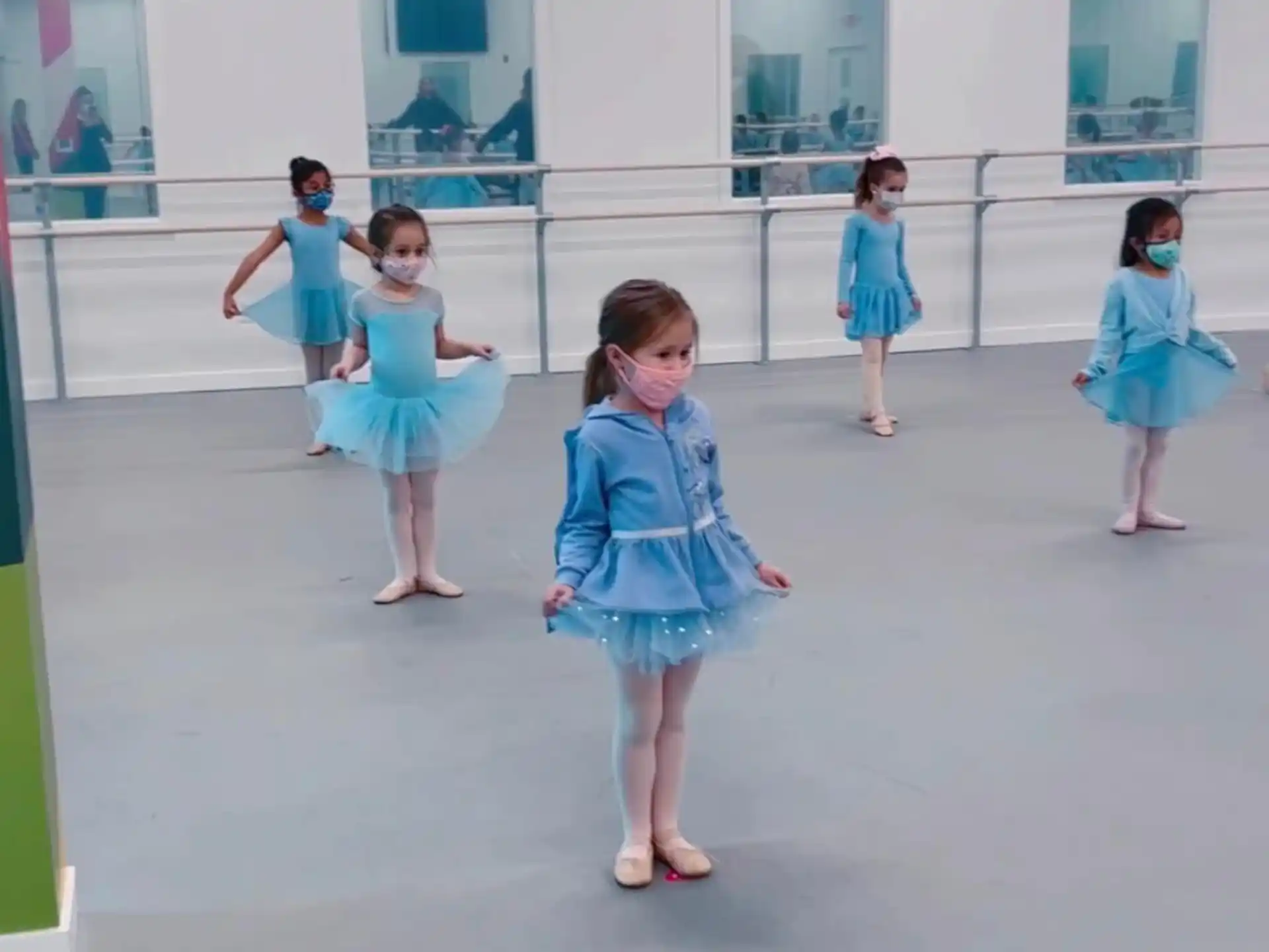 a group of girls in blue dresses