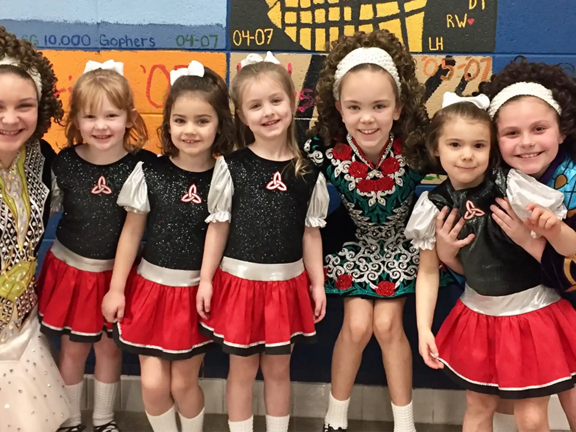 a group of girls in matching outfits
