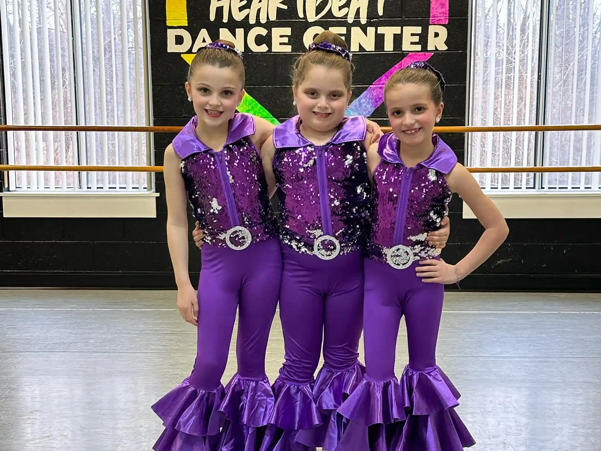 a group of children in purple and purple clothing
